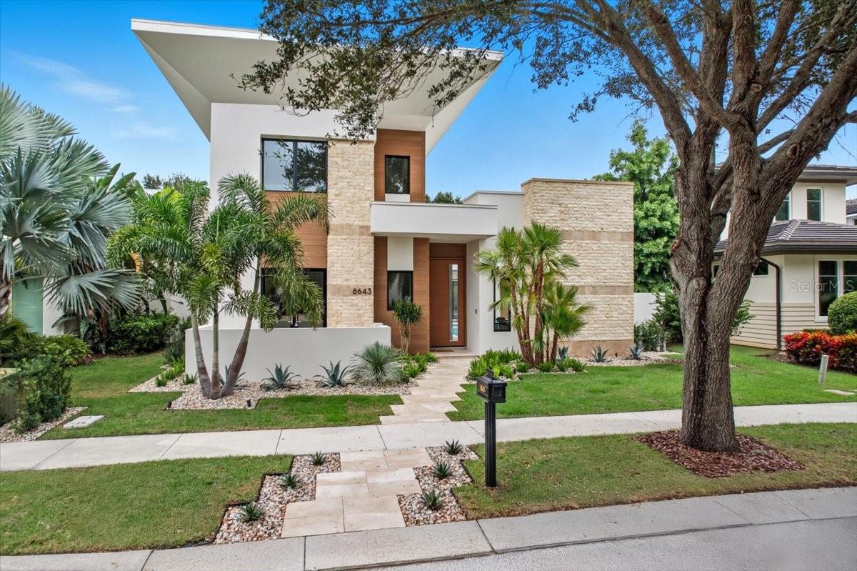 Situated on a lot spanning over a quarter of an acre, this stunning DeVoe Custom Home encompasses just under 5,500 square feet. It features five spacious bedrooms, five lavish bathrooms, and two additional half baths. Designed with both elegance and comfort in mind, this home showcases modern luxury seamlessly paired with timeless design elements.

Step into an open-concept living space, where soaring ceilings—exceeding 22 feet—combine with expansive windows to flood the home with natural light. The gourmet kitchen is equipped with top-of-the-line appliances, custom cabinetry, and a unique double kitchen island, making it the ideal space for entertaining and culinary creativity. Adjacent dining and living areas flow seamlessly, enhanced by bespoke finishes, a gas fireplace, and panoramic views of the manicured grounds.

The primary suite is a private sanctuary, featuring a spa-like bathroom with a soaking tub, dual vanities, a walk-in rain shower, and an immense, custom-designed closet. Each additional bedroom includes an en-suite bathroom and walk-in closet, ensuring both comfort and privacy for family members or guests.

Outside, the custom-designed spa and pool area provide the ultimate in relaxation, complete with a privacy wall for added seclusion. The landscaped yard offers ample space for outdoor gatherings, whether lounging poolside or dining al fresco on the covered patio.

Additional luxury features include a floating illuminated staircase with glass handrails, a temperature-controlled wine enclosure/display, and both upstairs and downstairs laundry rooms—each equipped with washer and dryer units. A dedicated utility storage room offers over 120 square feet of air-conditioned space, ensuring plenty of additional storage.

This home is perfect for hosting or enjoying peaceful, everyday luxury. Custom lighting and fixtures, a spacious three-car garage with dedicated space for golf cart parking, and a versatile office/flex space for work or hobbies round out the exceptional offerings.

Located in the heart of Lake Nona Golf & Country Club, this luxury estate provides unparalleled access to local amenities, fine dining, and top-rated schools. Floor plans are available upon request.