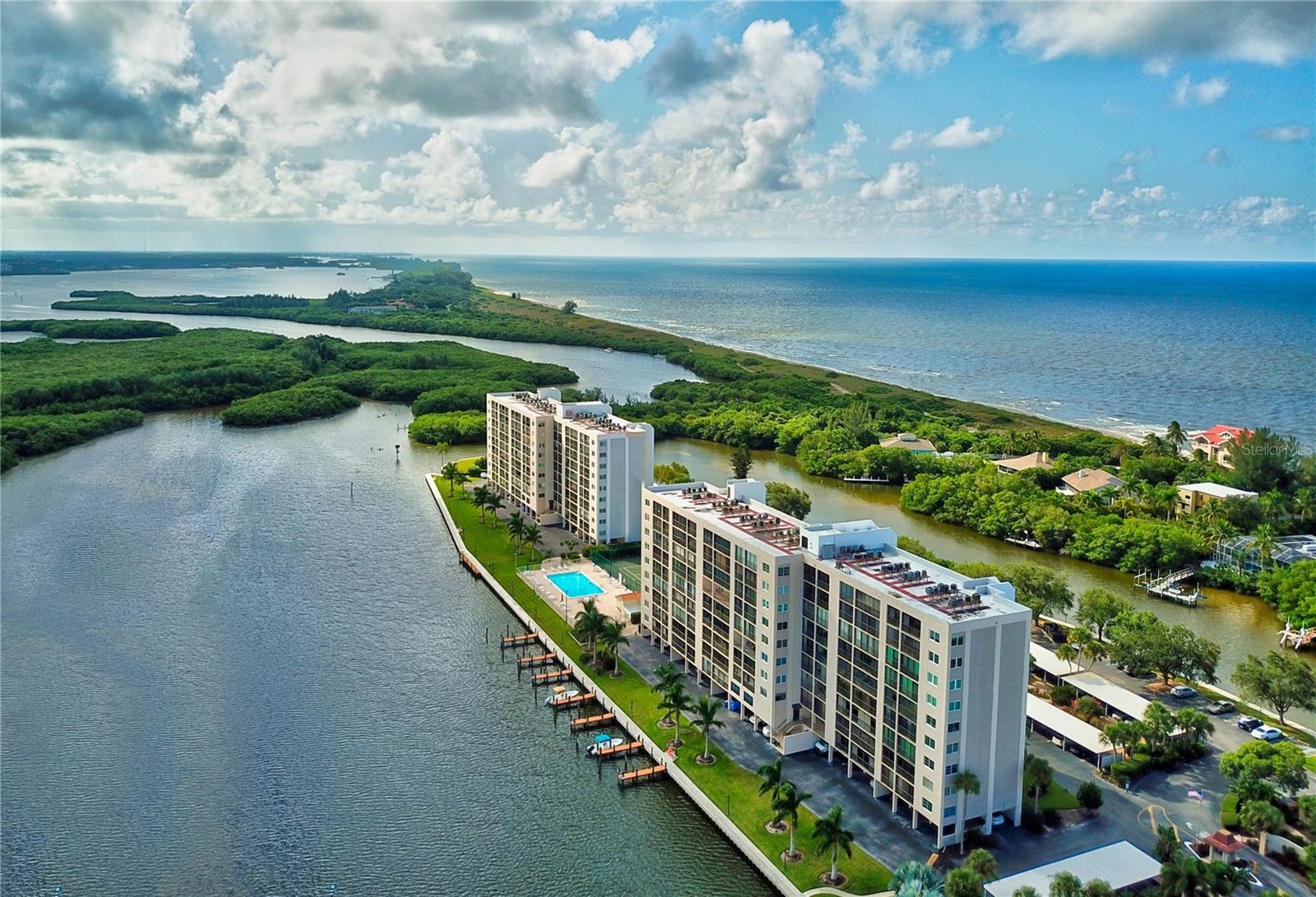 SIESTA KEY WATERFRONT. STUNNING SUNRISE/SUNSET & WATER VIEWS. **Gutted and beautifully renovated two-bedroom, two-bathroom 1630 square feet 7th-floor end unit condominium. in 2022, the owners and contractor utilized every inch of space AND took full advantage of the unrivaled water and nature views. To appreciate the attention to detail and all that is offered, this is truly a “must-see”.**  Situated on prime waterfront Siesta Key real estate, THE POINTE is a peaceful gated pet-friendly community offering boat docks, tennis and pickleball, heated lap pool, walking trail, BBQ grills, fishing, on-site management and more! * Larger of the two-bedroom floorplans at The Pointe, this beautifully renovated condominium provides picturesque views from every window! You and your loved ones will enjoy watching Siesta Key’s famous sunsets over the Gulf of Mexico as you sip your favorite beverage seated around the generous island in the spacious open-concept kitchen with quartz countertops, stainless appliances, under cabinet lighting, abundance of cabinetry and storage, hidden outlets, and soft-close cabinet doors.  And, if sunrises are your thing, wake up to the spectacular sun coming up over Sarasota Bay and Jim Neville Nature Preserve right from bed OR while settled on the spacious enclosed lanai. The primary bedroom with access to the lanai overlooking the bay offers a fabulous ensuite bath with double sinks, and a walk-in closet with a convenient laundry pass through. The guest bedroom – also with glorious bay and sunrise views – has convenient access to the guest bathroom and lanai, which houses another added storage closet.  **MOVE RIGHT IN, THE WORK IS DONE. There is a new HVAC system includes new ductwork with integrated UV air purifier and Smart thermostat. New water heater. New plumbing and electrical within unit. New luxury vinyl and tile flooring throughout.  Shiplap and coffered ceilings with recessed LED lighting. Beautiful custom tiled baths. Hard to find in most condominiums is a separate laundry room with space for a second refrigerator or freezer! And don’t forget about parking - made convenient with a desirable OVERSIZED (and coveted) under the building parking space with easy access to your separate ground floor storage area which comes with the unit. **THE POINTE is a private gated community offering the best of both worlds: activity and exercise, plus peace and tranquility. The property encompasses 5+ acres of waterfront property and offers amazing amenities.  Outdoor, fresh-air walkways to each unit. Boat docks w/electricity and water. Walking trails. Kayak/canoe launches. Heated outdoor lap pool. Spa. Tennis and pickleball courts. Dog walk. Strategically placed benches. Open-air gazebo w/BBQ grills. Cottage with full catering kitchen. Bike storage rooms. Separate entertainment rooms. A fitness center in each building. On-site management. ADVANTAGEOUSLY LOCATED. Nearby you will find fine and casual dining, Turtle Beach, a full-service marina, a campground on the beach nearby, shopping, coffee shops, grocery, nightlife, entertainment, Siesta Key beach, public transportation and much more - all on Siesta Key. ** Own a piece of paradise and watch the dolphin, manatees, birds, and sea life, fish off the dock, relax by the pool, play an invigorating game of tennis or pickleball, and watch the sunrise AND sunset privately, and quietly, from home.