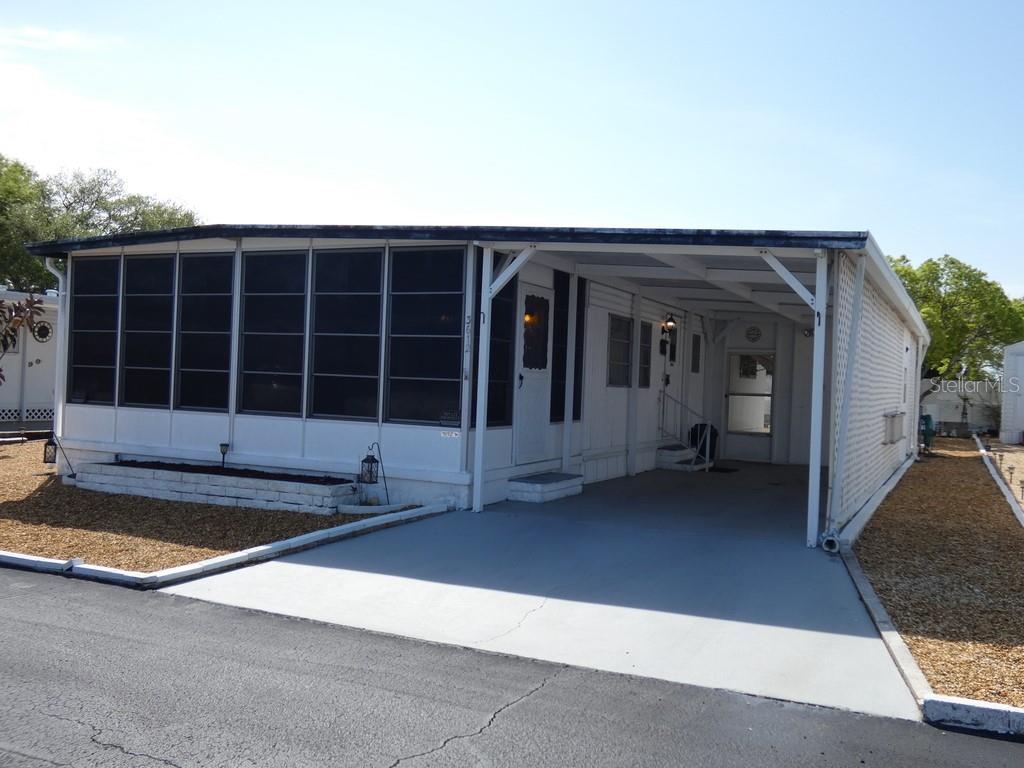 This 2 bedroom, 2 bathroom home located in Tiki Village MHP Condo (YOU OWN THE LAND) (NO LOT RENT HERE) offers a great opportunity to own in a gated 55+ community in Holiday, Florida. Per the county, this property is in a non-flood zone, which is a major benefit for many buyers. The home also features low HOA fees and no CDD, helping keep monthly expenses more manageable. Inside, you will find a functional layout with no carpet, making for easy maintenance and a clean, updated feel throughout. The design provides comfortable everyday living with two full bathrooms and a layout that works well for a primary residence or seasonal Florida retreat. The gated neighborhood adds an extra level of privacy and community appeal, while the 55+ setting offers a more relaxed lifestyle environment. With a combination of non-flood zone location per the county, low HOA, no CDD, gated 55+ community, no carpet, and a 2 bedroom, 2 bathroom layout, this property checks off key boxes buyers are actively looking for in today’s market. Please view two videos: Tour 1 & Tour 2
