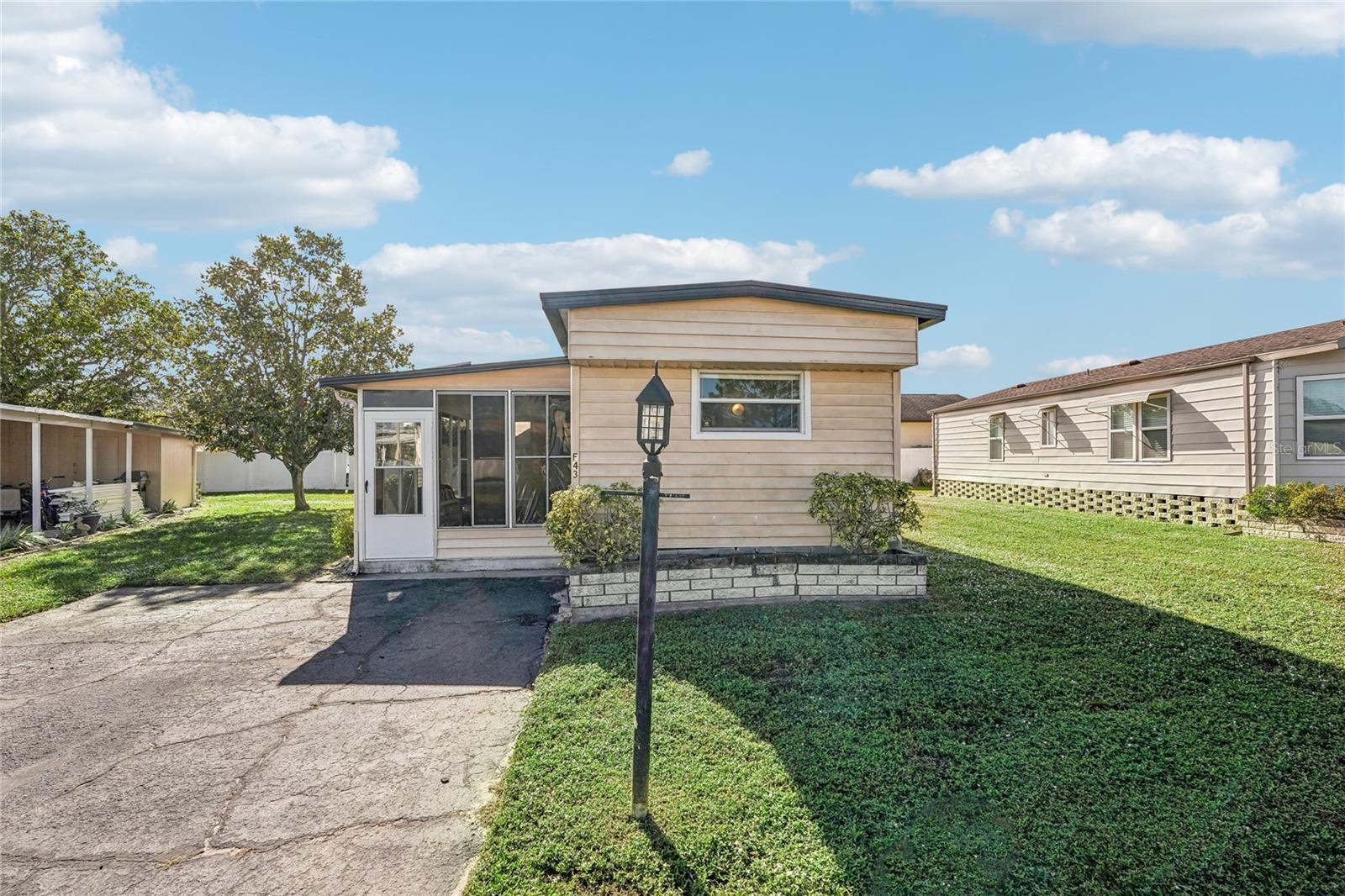 BRAND NEW A/C OCT 2025! Welcome to Westwinds Village, a charming 55+ age-qualified cooperative community in Bradenton, Florida. This is NOT LOT RENT, and the sales price includes a share in the community! This community has a great location on US-70, with quick access to the Gulf beaches, or to I-75. There are two entrances to the community, and there is a traffic light available as well for less stress! This home is located near the back entrance to the community, and is also close to the office and clubhouse! It's a single wide, but don't let that fool you. This is a TRUE 3 bedroom / 2 bathroom home! The carport isn't missing from the storm; this home never had one! You could add one if you wish, or leave it carport-free! But no carport to begin with means no damage from a missing carport from the recent hurricanes. In fact, this home has NO DAMAGE from the storms! When you approach the home, you'll first come upon the screened in lanai. It has vinyl windows, which you could either remove to have it just screened, or replace with glass windows. Inside, you'll notice the floor plan is split, with one bedroom (with an ensuite bathroom) in the front of the home, and the other two bedrooms in the back. These are the ORIGINAL OWNERS, and the home needs updating (there are a few soft spots in the floors, for example). However, it can be moved into immediately, with updates happening when convenient for you! The 2nd bedroom is small, and what some people have done in similar layouts is converted this room into a storage / laundry room. There is an old wall unit AC, but that can be removed when renovating, as the home is ducted with Central AC that was just replaced in October 2025! This home is sold FULLY FURNISHED and is ready for its new owners! Westwinds is one of the most amenity-rich communities in the area. Some of the amenities include: pool, clubhouse, shuffleboard, billiards, library, and lawn bowling! This home is ready for immediate closing; schedule your showing today!