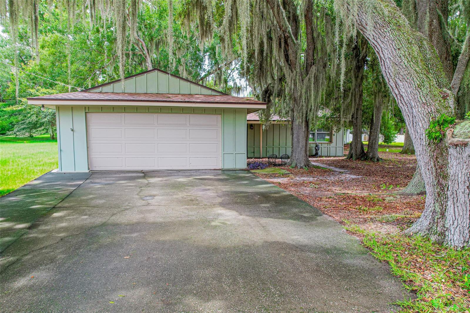 If you've been waiting for a home on Crystal Beach Road, you already know they don't come available very often. It's one of those roads where neighbors wave, the pace slows down just enough, and people tend to stay for a long time. Now, here's your opportunity.

Nestled on 1.5 beautiful acres with NO HOA, this property gives you the freedom to spread out, enjoy your space, and finally have room for all those hobbies you've been telling yourself you'll start someday. (Good news... the greenhouse is already here.) Sellers are also offering up to $10,000 in closing cost assistance for buyers. SCORE!

Major updates include a new roof (2020), freshly painted siding (2021), storage sheds with tie-downs (2021), a complete water system (2023), garage door opener and motor (2024), and a brand-new A/C (2025). Septic system Cleaned and inspected (2024), giving you confidence that the big-ticket items have already been addressed.

Inside, you'll find luxury vinyl plank flooring throughout, large closets, convenient attic storage, and an oversized garage with plenty of room for vehicles, tools, toys, or that workshop you've always wanted.

And the extras? They're the kind buyers love because they're already here. The washer and dryer stay, the ride-on mower stays (your back says thank you), the greenhouse stays, and the property is equipped with a whole-home propane generator, so when everyone else is hoping the lights come back on, you'll simply keep living life.

Florida weather? You're ready. Hurricane shutters for every window offer added protection and peace of mind when storm season rolls around.

This isn't just another house with acreage—it's a home that's been cared for, thoughtfully updated, and prepared for its next chapter. Whether you're sipping coffee as the sun rises over your property, working in the greenhouse, tinkering in the oversized garage, or simply enjoying the quiet that comes with country living, this is the kind of place that feels like home the moment you pull into the driveway.

Homes on Crystal Beach Road are rare for a reason. Come see why... and don't be surprised if you find yourself wanting to stay.