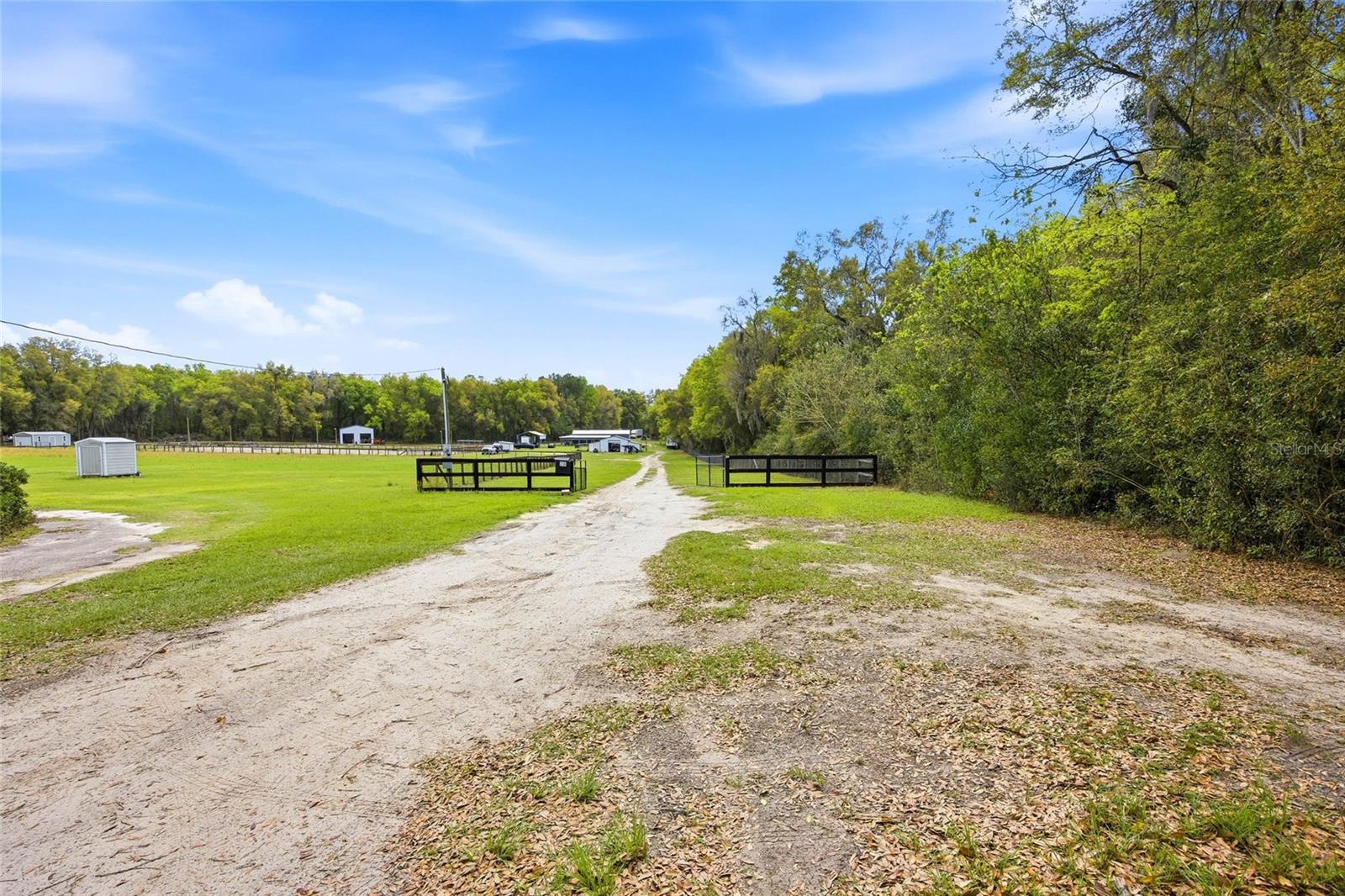 PRICE REDUCED!!! Seller Motivated. 10+ Acre Property with Extensive Improvements – Equestrian Ready
Exceptional opportunity to own a 10+ acre multi-use property with substantial infrastructure already in place. The land features approximately 6 cleared acres and 4 additional acres ready for clearing, offering ample room for expansion and future development.
This versatile property is ideal for equestrian use, agricultural operations, RV accommodations, commercial use, or investment purposes.
Improvements & Structures:
Main Shop: 38 x 40 ft
Workshop: 30 x 50 ft
Storage Building: 36 x 60 ft, equipped with washer, dryer, and refrigerator, plus two additional floors under construction for future projects
RV Cover: 20 x 36 ft
Carport: 12 x 20 ft
Equestrian Facilities:
Barn: 36 x 60 ft with 11 horse stalls and 1 tack room
Horse shower/wash rack
Multi-purpose riding arena: 120 x 200 ft with lighting, suitable for all types of equestrian activities and events
Utilities & Features:
Two separate electric meters
Water well with pump
Septic system
Four RV hookups
This property offers a rare combination of usable acreage, functional improvements, and flexibility, making it an excellent choice for a working ranch, equestrian center, business operation, or future development.
Property is operational and ready for immediate use, with room to grow.
Located in a desirable area with easy access to Ocala's amenities and with an easy commute to WEC and Hits showgrounds while still enjoying the peace and quiet of rural living. Whether you're looking to start a farm, invest in land, or build a private retreat, this property offers a rare combination of convenience, space, and potential.