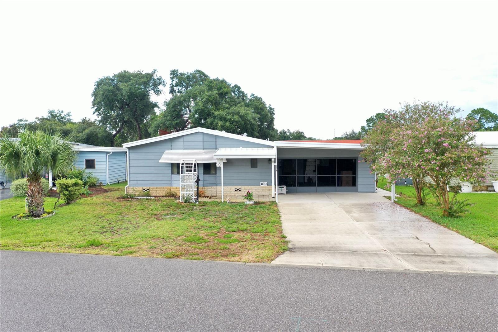 Welcome Home to Fox Run, a resident owned community in Tavares Fl, The seaplane capital! This beautiful and large 2 bedroom 2 Bath home is located in an ideal location, near the community center with pools, club house and actives and overlooks the pond with a calming water feature you can enjoy from your panoramic views in the Living room or the lake facing bonus air-conditioned sunroom. When you pull up to the home, you have a large 2 car garage with sliding screen door, step into the home to the indoor laundry and office. You have the kitchen, dining and living room to your right and very large bedrooms with tons of closet space including a dual walk in closets in the master. The home has been well taken care of and is waiting for its new owner.