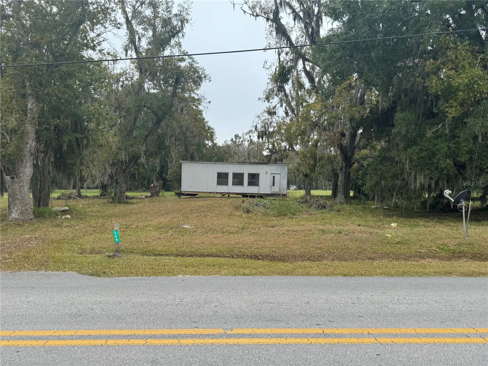 Prime 100’ x 115’ lot in the heart of Starke—ideal for investors or business owners. Includes a 12’ x 36’ modular building that can be converted into an office or other commercial use. Interior updates are needed, giving buyers the chance to finish it to their needs. On-site utilities include city water, electric, and septic. The lot provides 100’ of frontage and 115’ of depth, faces north, and sits within city limits for easy access to local amenities and downtown attractions. This visible location is directly across from the Bradford County Fairgrounds and near: Call Street Historic District – shops and restaurants Florida Twin Theatre – historic Art Deco cinema Starke Downtown Music Pavilion – festivals and events Eugene L. Mathews Historical Museum – exhibits in the courthouse Buyer must verify allowable business operations with the City of Starke. A strong mix of location, visibility, and development potential in historic downtown Bradford County.  Owner Financing Available.