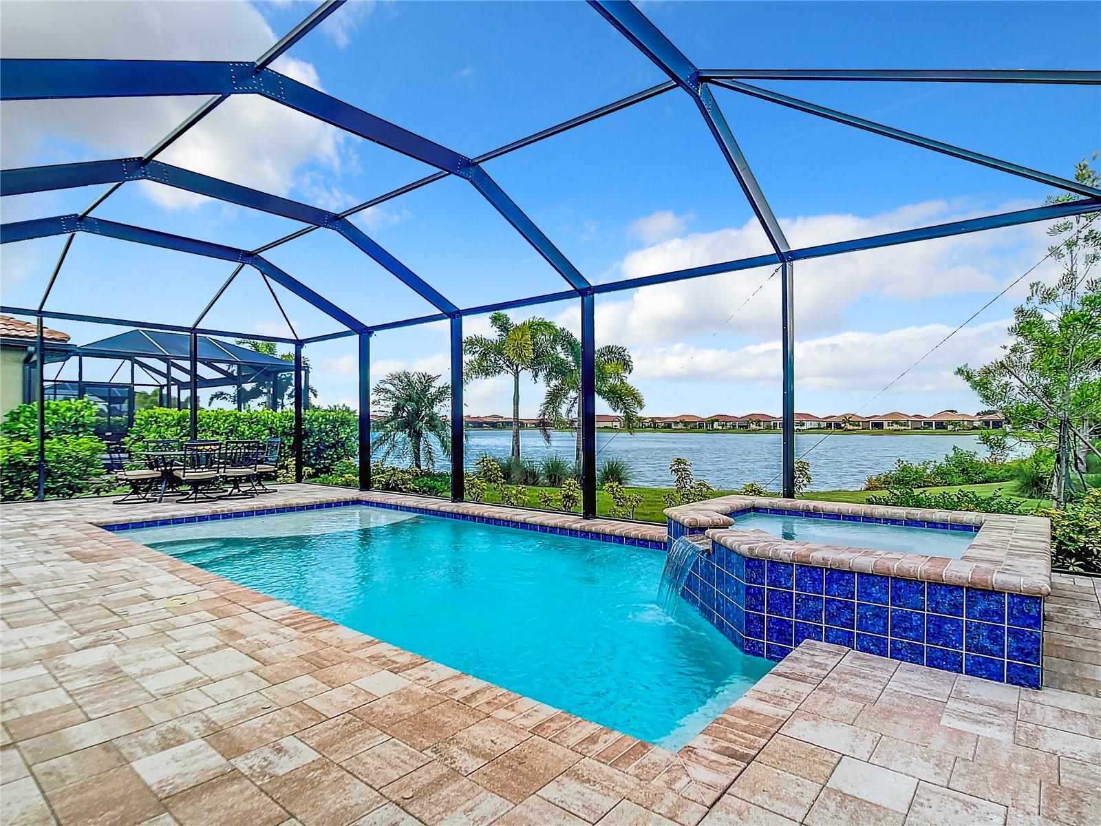 Welcome to Toscana Isles, a vibrant and newer community just minutes from the beautiful beaches of Nokomis and Venice. This serene lakefront retreat, conveniently located near the new Sarasota Memorial Hospital, features a stunning 3-year-old home with breathtaking lake views and spectacular sunsets visible from your private screened-in pool area. The thoughtfully designed split-bedroom layout places the main suite at the back, offering direct views of the pool, spa, and lake. On the opposite side, a second bedroom, a versatile den/third bedroom, and a full bath provide privacy and flexibility. At the heart of the home, the spacious great room and kitchen, with 42-inch cabinets and a large center island, create an ideal space for gatherings. Additional features include an expanded patio for extra outdoor space, a heated saltwater pool and spa with app-controlled settings, ceiling fans in every room and the patio, 4 TV wall mounts, a Kinetico water purification system, and a three-camera ADT security system with smart home controls for locks, lights, and the garage door. This home offers incredible value as one of the most affordable lakefront pool homes in the neighborhood, complete with unforgettable sunset views. Schedule your sunset showing today!