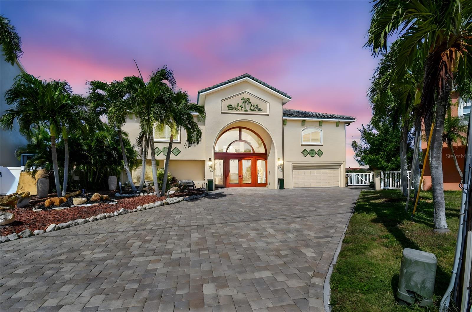 Enjoy an exquisite 6,504 sq. ft. open water estate home on Madeira Beach’s limited access Crystal Island.  This home offers 200 feet of open bay frontage at the end of a private cul-de-sac and was completely reimagined in 2013 with all new construction including roof, electric, plumbing, travertine floors, and hurricane-grade windows & doors, this residence blends elegance with peace of mind. This residence, with 4,255 HSF, welcomes you with a grand two-story entry and glass elevator.  Grand staircase leads to a spacious second-floor great room with a full wall of sliders all opening to 1,461 sq. ft. balcony and spectacular open water views. The updated gourmet kitchen features stainless steel appliances, a large island with seating leading to open dining and living areas, ideal for entertaining bringing the outdoors in and inviting guests to enjoy the best in waterfront Florida living. Two master suites with luxurious ensuites complement three additional bedrooms and baths, plus a private mother-in-law suite on the lower level with direct bay access. Outdoor living shines and continues with another 1,125 sq. ft. covered porch featuring an outdoor kitchen, ample shaded seating and dining areas along with game area with Ping Pong, Table Tennis, Darts and fireplace.  All this opens to the 40' pool and waterfall hot tub, and then a large pavered patio with comfortable lounge chairs for sunbathing.  Added is a semicircular seated fire pit area for evening get togethers, cocktails and stories of the day’s activities.  These likely came from the watersport fun from your array of toys, or your boats or trip on your yacht all kept at your updated deep-water dock equipped with power and water, as well as two lifts and large dock. The grounds are immaculately designed with water features and landscaped grounds at the front of the home and large available open astro-turfed areas in back.  3 Sheds provide additional storage and dual system ACs, and equipment are all out of view, but provide all the comfort expected.  All of this is nestled within the limited-access Crystal Island subdivision of Madeira Beach - known for its golf-cart-friendly streets, award-winning beaches, lively City amenities including local festivals, boat parades, parks, libraries and more, and proximity to the shops, dining, and entertainment of Johns Pass Village - this home combines luxury and convenience. Just 35 minutes to Tampa International Airport and 25 minutes to St. Pete-Clearwater Airport, residents also enjoy quick access to the renowned arts districts of downtown St. Petersburg and championship sports franchises including the Tampa Bay Rays, Rowdies, Lightning, and Buccaneers and more.  Just a day trip to some of the world's best theme parks means living here checks off all the boxes of luxury living along Florida’s best waters.