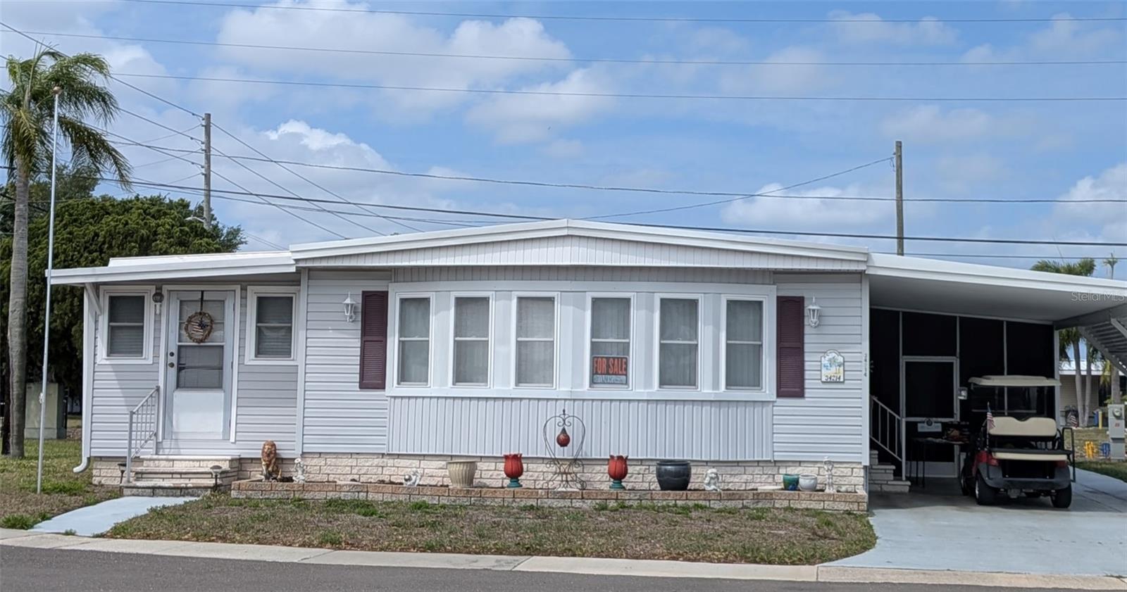 Beautiful Home on the largest Corner lot in the park!!  Furnished 2bed 2 bath home in Top retirement park, Sunset Palms 55+ Share owned community! Land Share value $55,000!  Doublewide with additional family room on left of home, plus a screened in patio with TV under the cart port on right side!!  Because it is share owned, you only pay $210. a month, which includes all the amenities you could want; WATER, SEWER, TRASH, owned clubhouse, escrows are fully funded, beautiful, heated pool, and spa, fitness center, library, shuffleboard, billiards, lake at the back of park, laundry room, there is also a private golf cart trail to Walmart!  Also, minutes away from Gulf Beaches, Tampa bay Buccaneers Stadium, Rays Baseball, and Lighting Hockey!!  Location!!  Location!! Location!!  WELCOME HOME!!