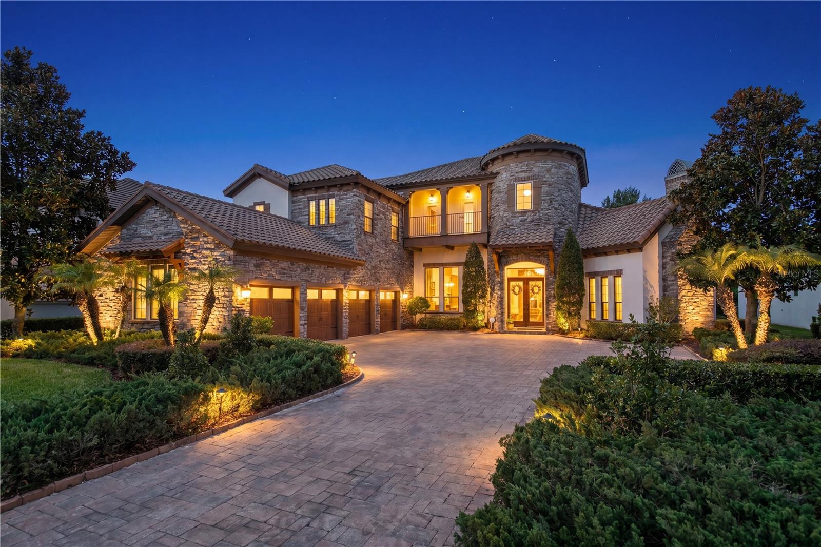 Welcome to an extraordinary custom residence where award-winning design, impeccable craftsmanship, and resort-inspired living come together in the prestigious gated community of FishHawk Preserve. Perfectly positioned on a private 0.35-acre conservation homesite, this stunning WestBay "Venezia" model offers an unmatched blend of luxury, comfort, and sophistication while residents enjoy exclusive community amenities, a vibrant family-friendly atmosphere, miles of scenic trails, and access to top-rated schools in one of FishHawk's most coveted neighborhoods. A grand foyer introduces the home's breathtaking architectural design, where soaring ceilings, elegant finishes, and thoughtfully curated details create an unforgettable first impression. The expansive floor plan was designed with both everyday living and grand-scale entertaining in mind, seamlessly connecting formal gathering spaces with warm, inviting family areas. At the heart of the home lies a truly spectacular chef's kitchen that will delight even the most discerning culinary enthusiast. Outfitted with premium Wolf stainless steel appliances, Zodiaq quartz countertops, a Sub-Zero ice maker, warming and cooling drawers, custom cabinetry, and an oversized center island, this remarkable space blends beauty and function while overlooking the spacious grand room, creating the perfect setting for entertaining family and friends. The luxurious owner's retreat is privately tucked away, creating a peaceful sanctuary to unwind at the end of the day. Designed with comfort and elegance in mind, this spa-inspired suite offers a tranquil escape from the rest of the home. Three additional generously sized bedrooms each feature their own private en-suite bathrooms, providing exceptional privacy and comfort for family members and overnight guests alike. Every room showcases the exceptional craftsmanship that defines this award-winning residence. Rich travertine flooring, dramatic tray ceilings, exposed wood beams, intricate custom millwork, multiple gas fireplaces, integrated surround sound, security cameras, and designer finishes combine to create a home where no detail has been overlooked. The thoughtfully designed second level is dedicated to entertainment and relaxation. An extraordinary media room delivers a true luxury theater experience, complete with blackout curtains, a convenient kitchenette, and a full bath, making it the perfect destination for movie nights, game days, hosting overnight guests, or simply relaxing in complete comfort. Just beyond, an expansive bonus room opens onto a covered terrace overlooking the resort-style backyard and peaceful conservation views, providing yet another exceptional space for gathering and entertaining. Step outside and experience your own private resort. Designed for year-round Florida living, the spectacular outdoor oasis features a fully equipped outdoor kitchen, an elegant cabana with a cozy fireplace, expansive covered living areas, and a breathtaking infinity-edge pool with a heated spa, all perfectly positioned to capture serene conservation views while offering exceptional privacy. This is more than a home—it's a lifestyle. Rarely does a home of this caliber become available in one of FishHawk's most sought-after luxury communities, offering an unparalleled blend of privacy, prestige, and everyday convenience.