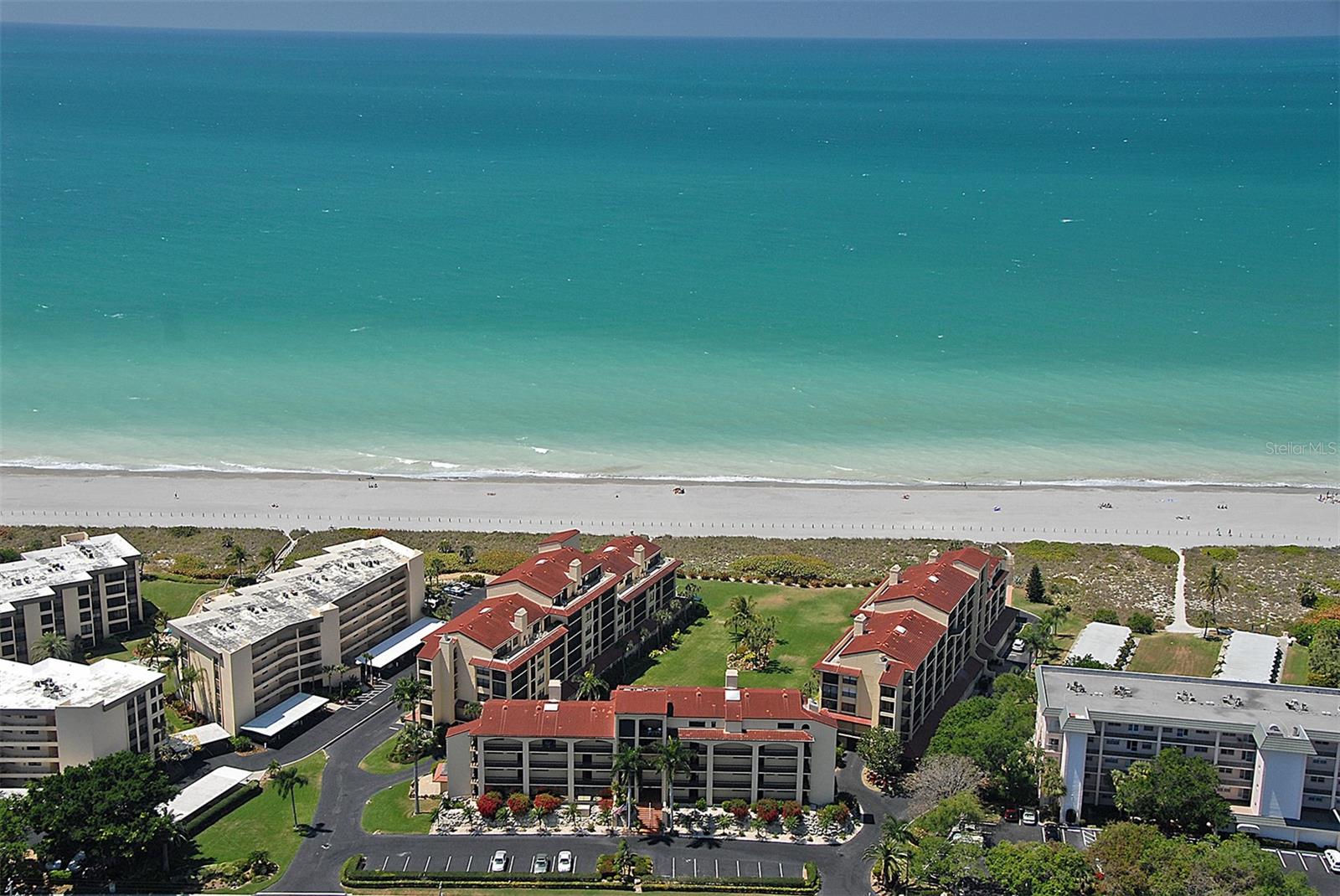 Looking for a beach front condo on Siesta Key? Wait until you see Tortuga condominium complex.  This private gated community is the slice of paradise you have been looking for. Amenities include heated community indoor/outdoor pool, sauna. The clubhouse has been renovated and, with its full kitchen and dining area, can be reserved for a private gathering! This 2 bedroom, 2 bath condo is updated throughout with hurricane sliding doors and is being sold turn-key furnished!  You have a water view of the Gulf. The best part of this condo is that it is rented December 28, 2025 through March 2026!  Tortuga amenities extend to the Bay side also!! Included are boat docks, a fishing pier, tennis and pickleball courts. Tortuga assigned boat slips are 10.5ft wide by 30ft long. So, length including bow anchor platform, swimming platform, engine mount, protruding propeller, or any other extensions cannot exceed 30ft. HOA fees include basic cable and internet, water, trash pickup and an onsite maintenance manager. Whether you envision it as your permanent sunny abode, a splendid second home, or a savvy investment, your own piece of paradise awaits!