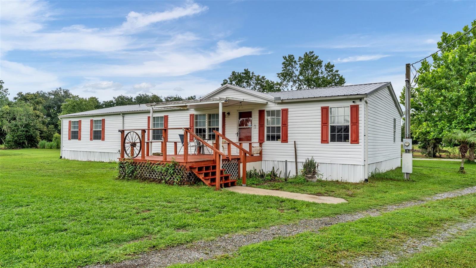 Welcome to 6702 Forestview Lane, where peaceful country living meets an exceptional South Lakeland location. Tucked away at the end of a quiet dead-end street just off County Line Road, this rare property offers nearly 2.5 fully fenced acres of privacy, open space, and endless possibilities—all with no HOA.

This beautifully maintained home features 4 bedrooms, 3 bathrooms, plus a dedicated office with a closet and window, ideal as a fifth bedroom, nursery, or work-from-home space. Offering 2,170 square feet of living space, the split-bedroom floor plan is complemented by vaulted ceilings, two spacious living areas, and a cozy wood-burning fireplace that creates a warm and inviting atmosphere.

The kitchen overlooks the living spaces and opens to a screened rear porch, where you'll enjoy peaceful views of your private acreage. Outside, a tranquil pond with a decorative fountain, mature oak trees, lush landscaping, and expansive green space create the perfect backdrop for entertaining, gardening, recreation, or simply embracing the quiet country lifestyle.

The versatile barn provides abundant storage, covered parking, and a finished bonus room ideal for a workshop, hobby space, home gym, office, or studio. With nearly 2.5 fenced acres, there's ample room for RVs, boats, trailers, recreational vehicles, and all of your outdoor equipment.

Designed for comfort and peace of mind, the home features a metal roof, 2021 HVAC, 2020 water heater, remodeled guest bathroom, Low-E thermal windows, private well with Culligan water softener, updated well houses, septic serviced in 2024, improved site grading, and beautifully maintained landscaping. Additional conveniences include an ADT security system with video doorbell, Spectrum high-speed internet, and Lakeland Electric service.

Adding even more long-term appeal, the property is located within Polk County's Residential Suburban (RS) Future Land Use District, and county planning staff has indicated the parcel appears to be a vested buildable lot under previous zoning requirements, offering exciting future potential. Buyers should complete their own due diligence with Polk County regarding future land use and development opportunities.

Conveniently located in South Lakeland with easy access to both Polk and Hillsborough Counties, you'll enjoy the tranquility of country living while remaining just minutes from shopping, dining, schools, medical facilities, and major commuter routes.

Whether you're searching for a private family estate, space for animals, room for your RV and boats, or simply a peaceful place to call home, 6702 Forestview Lane offers a rare opportunity to enjoy the best of Central Florida living.