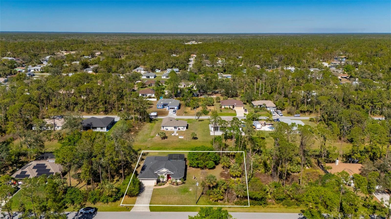 Welcome to this exceptional one-owner 3-bedroom, 2-bathroom pool home, perfectly positioned on an oversized double lot .47 acres and loaded with high-end upgrades, quality craftsmanship, and true pride of ownership throughout. NO HOA, NO CDD, NOT IN FLOOD ZONE. From the moment you arrive, you’ll be captivated by the immaculate curb appeal featuring lush tropical landscaping, vibrant greenery, custom paver walkways, and a beautifully maintained exterior that immediately showcases the care this home has received over the years. Major exterior improvements include a new roof installed in November 2022, new gutters and soffits, impact-resistant windows, and impact pocket sliders, providing superior storm protection, energy efficiency, and peace of mind.
Step inside to discover a spacious open-concept floor plan filled with natural light and designed perfectly for both entertaining and everyday living. The oversized kitchen is truly the heart of the home and offers gorgeous Corian countertops, an abundance of cabinetry, a large pantry, newer stainless steel appliances, and expansive counter space ideal for cooking and gathering with family and friends. The kitchen overlooks the main living and dining areas, creating a seamless flow throughout the home. The spacious primary suite serves as a private retreat featuring a walk-in closet and an ensuite bathroom, while the additional guest bedrooms offer generous space and flexibility for visiting guests, a home office, or hobby room.
This home is packed with valuable upgrades including all-new insulation installed in 2022 for enhanced energy efficiency, a complete HVAC system replaced in 2018, a new water heater installed in April 2026, a whole-house reverse osmosis system providing purified water throughout the home, and a septic system inspected and pumped in September 2024. A rare stand-up attic provides excellent additional storage space, adding even more functionality to this already impressive property. The large laundry room offers plenty of storage, while the oversized 2-car garage provides ample room for vehicles, tools, and recreational equipment.
Step outside through the impact pocket sliders into your own private Florida oasis. The beautifully screened-in pool area features a sparkling pool, an oversized covered lanai, and a spacious sitting area perfect for entertaining, relaxing, or enjoying peaceful Florida evenings. The indoor and outdoor surround sound system creates the perfect atmosphere for gatherings and outdoor living. Furniture is negotiable, making this incredible property even more move-in ready. To provide additional confidence for buyers, the seller has already completed a full home inspection. This truly stunning property offers the perfect combination of luxury, comfort, space, and functionality in a highly desirable setting. Schedule your private showing today before this rare opportunity is gone.