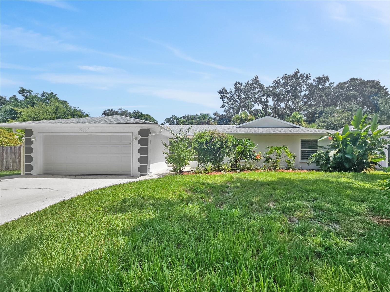 $600.00 in Free Rent prorated over 12 months as a monthly rent reduction! Base Rent $2,395.00 with$50.00 off each month for 12 months!! 
Welcome to this beautifully maintained 3 bedroom, 2 bathroom home boasting 1,714 square feet of comfortable living space at 3119 Mango Tree Dr in Edgewater, Florida. Situated in a desirable Volusia County neighborhood, this charming property catches your eye immediately with its classic Florida stucco exterior and an attached two-car garage. Step inside to find an expansive, sun-drenched open floor plan featuring clean tile flooring at the entry and plush neutral carpeting throughout the main living spaces. The massive living area is anchored by a cozy fireplace and flows effortlessly into the dining room and kitchen, making it perfect for both daily living and effortless entertaining. Down the hall, the spacious primary suite serves as a relaxing retreat, complete with dual closets and a private en-suite bathroom. The additional bedrooms are generously sized, offering flexible space with large windows that let in plenty of natural light. Step out back to enjoy the warm Florida weather from your screened-in patio, overlooking a fenced backyard that includes a practical tool shed for extra storage.