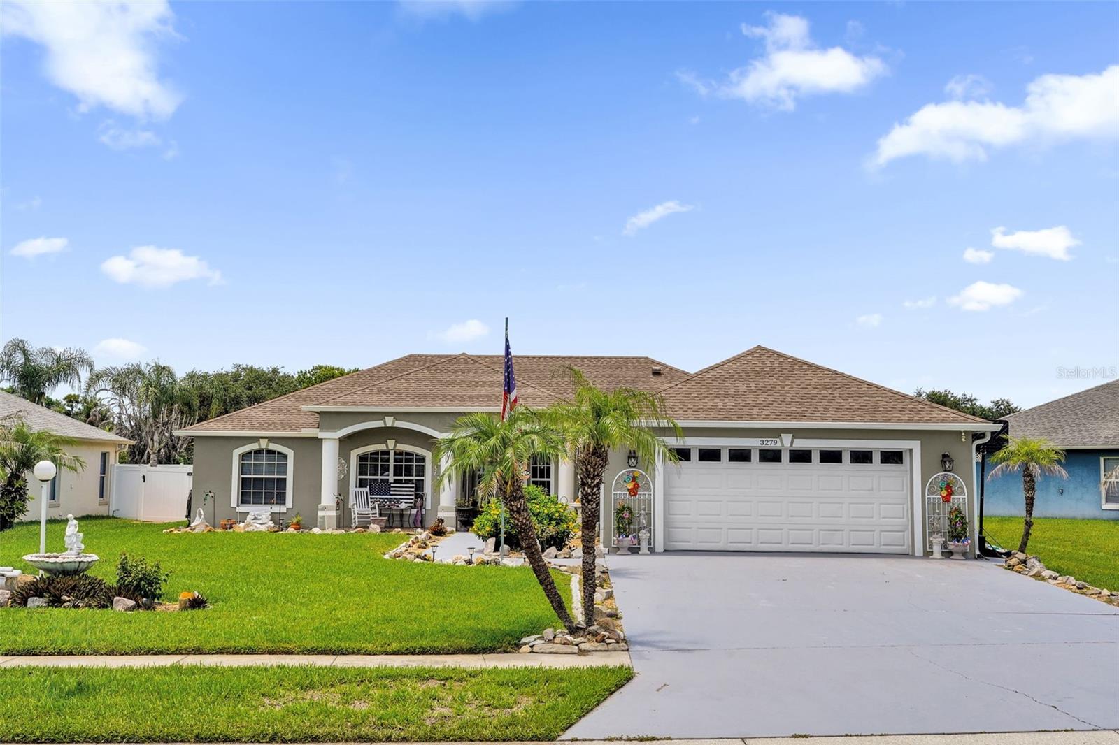 Welcome home to this beautifully updated pool home situated on an oversized homesite, providing additional yard space, enhanced privacy, and outstanding curb appeal. With one of the area’s lowest HOA fees at just $493 per year, this home offers exceptional value while combining quality updates with inviting indoor and outdoor living spaces. A decorative tile front porch welcomes you inside, where you’ll immediately notice the elegant decorative tile medallion in the foyer, setting the tone for the craftsmanship found throughout the home. The open floor plan features ceramic tile and wood laminate flooring throughout with absolutely no carpet, complemented by crown molding that adds a touch of sophistication. The spacious living room serves as the heart of the home and is highlighted by a beautiful stone accent wall, creating a warm and inviting focal point. The kitchen is both stylish and functional with rich espresso cabinetry, granite countertops, a tile backsplash, and stainless steel appliances, including a desirable double wall oven. The adjacent dining area provides plenty of space for family meals and entertaining while overlooking the backyard oasis. Designed for true Florida living, two sets of triple sliding glass doors open to the expansive screened lanai and sparkling swimming pool, seamlessly blending indoor and outdoor living. The oversized backyard offers additional room to enjoy, complete with a charming gazebo for relaxing or entertaining and a storage shed for extra convenience. The spacious primary suite is a private retreat featuring a tray ceiling and an updated spa-inspired bathroom with granite countertops, dual vessel sinks, and a beautifully remodeled walk-in shower featuring a frameless glass enclosure and a luxurious ceiling-mounted rainfall shower head. The guest bathroom has also been tastefully updated with granite countertops and a modern vessel sink, providing a cohesive look throughout the home. Additional improvements include a roof replaced in 2017, a well-appointed laundry room with built-in cabinetry and a utility sink, and numerous quality finishes that make this home truly move-in ready. Conveniently located near shopping, restaurants, schools, parks, golf, and major roadways, this exceptional property offers the perfect combination of modern updates, outdoor living, and an unbeatable location. Don’t miss your opportunity to own this beautifully maintained home with low HOA fees, an oversized homesite, and all the features today’s buyers are looking for.