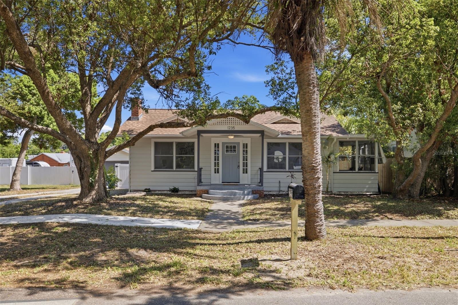 Virtually Staged. Step into the timeless charm of this beautifully renovated 1930s Florida cottage bungalow, where historic character meets thoughtful modern updates. From the moment you enter, you'll appreciate the inviting living space centered around a charming fireplace—a true rarity in Florida—paired with new recessed dimmable lighting, updated ceiling fans, and a warm, welcoming atmosphere. The completely refreshed kitchen features butcher block countertops, a large stainless steel sink, and tasteful finishes that complement the home's original character. The beautifully updated bathroom blends modern style with classic charm, while an additional light-filled bonus room surrounded by windows offers the perfect space for a home office, reading room, playroom, or creative studio. An interior laundry room conveniently located just off the kitchen means no trips through the garage on hot summer afternoons or rainy Florida days. Situated on an oversized 8,000 sq. ft. lot, this property offers something exceptionally difficult to find: two detached garages. In addition to the one-car garage, the property features an oversized approximately 800 sq. ft. two-car garage complete with its own electric meter. Rare Value-Add Opportunity! One of the property's most exciting features is its LMDR zoning, which, combined with the oversized detached garage, presents outstanding potential for a future Accessory Dwelling Unit (ADU) conversion, subject to City of Clearwater approval and permitting. Whether you're envisioning future rental income, multigenerational living, a private guest suite, home office, fitness studio, workshop, or creative space, this versatile structure offers flexibility that is rarely available in this location. Located in a desirable golf cart-friendly neighborhood, you'll enjoy easy access to everything that makes this area so special. Cruise to vibrant Downtown Dunedin for restaurants, breweries, boutique shopping, and community events, or spend the day enjoying the world-renowned beaches of Clearwater Beach and Honeymoon Island State Park. The home is just minutes from Downtown Dunedin, approximately 15 minutes to Clearwater Beach, and conveniently located near parks, marinas, golf courses, and the Pinellas Trail. Recent improvements include: •Updated kitchen with butcher block countertops and oversized stainless steel sink •Beautifully renovated bathroom •New flooring throughout •New recessed dimmable lighting •New ceiling fans • New roof on the rear garage/storage building •Interior and exterior improvements throughout.  This is more than a beautifully renovated bungalow—it's a property that combines historic charm, modern comfort, and exceptional future potential in one of Clearwater's most desirable locations.