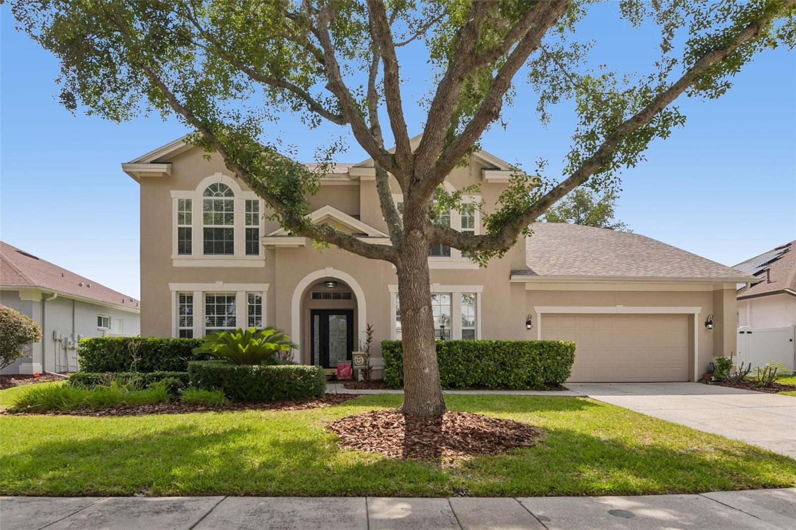 This stunning, two-story POOL home in the highly sought-after, gated community of Arbor Greene delivers!  Boasting a newer roof (Sept '23), dual HVAC units, a newer natural gas water heater, a Rainsoft water softener system, garage storage, and 19 new window screens (June '26). The elegant interior greets you with seamless new tile flooring spanning the entire first floor (Dec '21), which guides you past a private, dedicated home office with closing French doors, a formal dining room, and a laundry room with a newer washer and dryer (Dec '22) into a spacious living room with dramatic cathedral ceilings. The adjacent gourmet kitchen features a center prep island, gas range, premium granite countertops, and beautifully resurfaced cherry cabinets. Also on the main level, the remodeled primary retreat offers a peaceful sanctuary with a walk-in closet and direct outdoor access, while a beautiful stairway leads upstairs to a versatile bonus room loft and comfortable, carpeted secondary bedrooms—bringing the total layout to four bedrooms, one office, three and a half bathrooms, a bonus room, and an oversized 3-car tandem garage, with select interior furnishings available as negotiable. Designed for ultimate outdoor enjoyment, the huge brick paver lanai features a new screen (May '23) and wraps around a 14,000-gallon, inground pool and spa heated by natural gas.  This all highlights a dedicated outdoor cooking station equipped with power, lighting, a Big Green Egg, and a built-in spot for a Blackstone flat grill.  Last but not least, A dedicated TV and a perfect view looking out to a private backyard fully enclosed by a newer vinyl fence with two gates (Dec '24). Settled in a vibrant, master-planned community, residents enjoy resort-style amenities like clay tennis courts, pickleball courts, a fitness center, resort and fitness pools, scenic nature trails, parks, and a clubhouse, all with unparalleled convenience to I-75, Wiregrass Mall, premier dining, shopping, hospitals, the new performing arts center, USF, Downtown Tampa, and Tampa International Airport.
