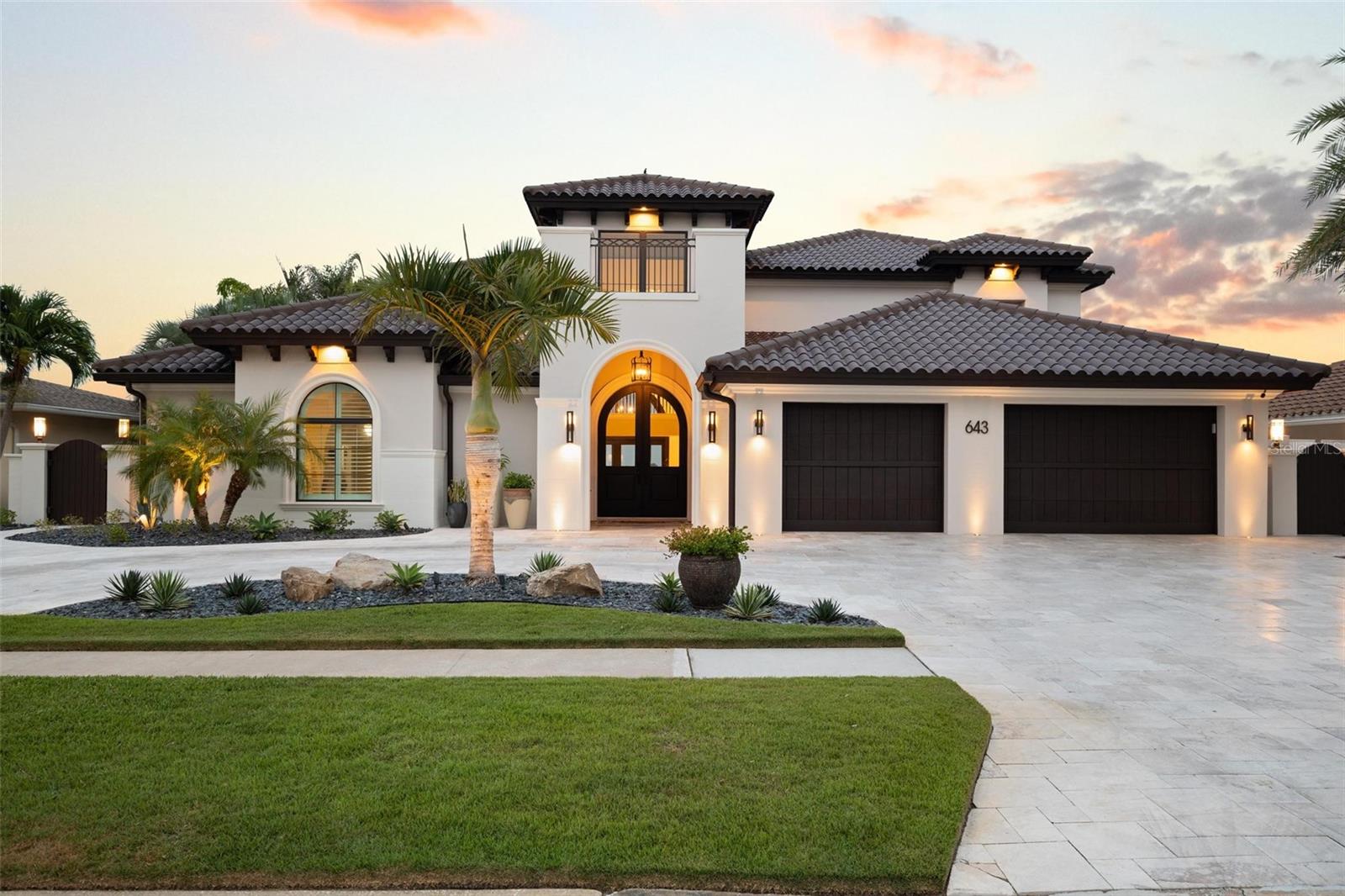 In the heart of Clearwater’s most elite waterfront enclave, this home stands as the architectural jewel of Island Estates. Featuring the best open water vistas and unparalleled sophistication, this property offers a unique island-like feel, despite being moments away from Clearwater Beach’s prime locations. Every detail is curated, welcoming you with a circular travertine drive, then immediately revealing views of Clearwater Harbor through the front entry. Refined appointments include a soaring foyer with a hand-crafted chandelier, wood/travertine inlay flooring, and a family room which offers indoor/outdoor living on the Harbor. The custom millwork includes architectural beams and entry doors, a testament to the meticulous attention to detail and craftsmanship. First-floor master suite features open water views and a private balcony with seating for two. The master bath is beyond compare, Venetian plaster cathedral ceilings, freestanding tub, rain shower and more. Chef style kitchen includes leather-finish marble, gas stove top, and custom cabinetry with paneled appliances. A temperature controlled wine cellar is located off the kitchen, storing up to 800 bottles. The office is located on the second floor of the master wing, with an air purifying system, private balcony overlooking Pope’s channel, and a Murphy bed for extra guests. Two of the guest bedrooms share balconies with breathtaking views. The third guest room features a private, en-suite bath. The outdoor oasis was designed for a truly visceral experience; fire-pots, waterfalls, LED lighting, surround sound, Rip Rap Seawall and privacy create an unmatched Paradise. When you want to explore the seas, there’s a Deep Water Boat Slip with easy Gulf Access. Custom renovation and upgrade documentation available upon request; including but not limited to blueprints, renovation site plans, appliance and fixture information.