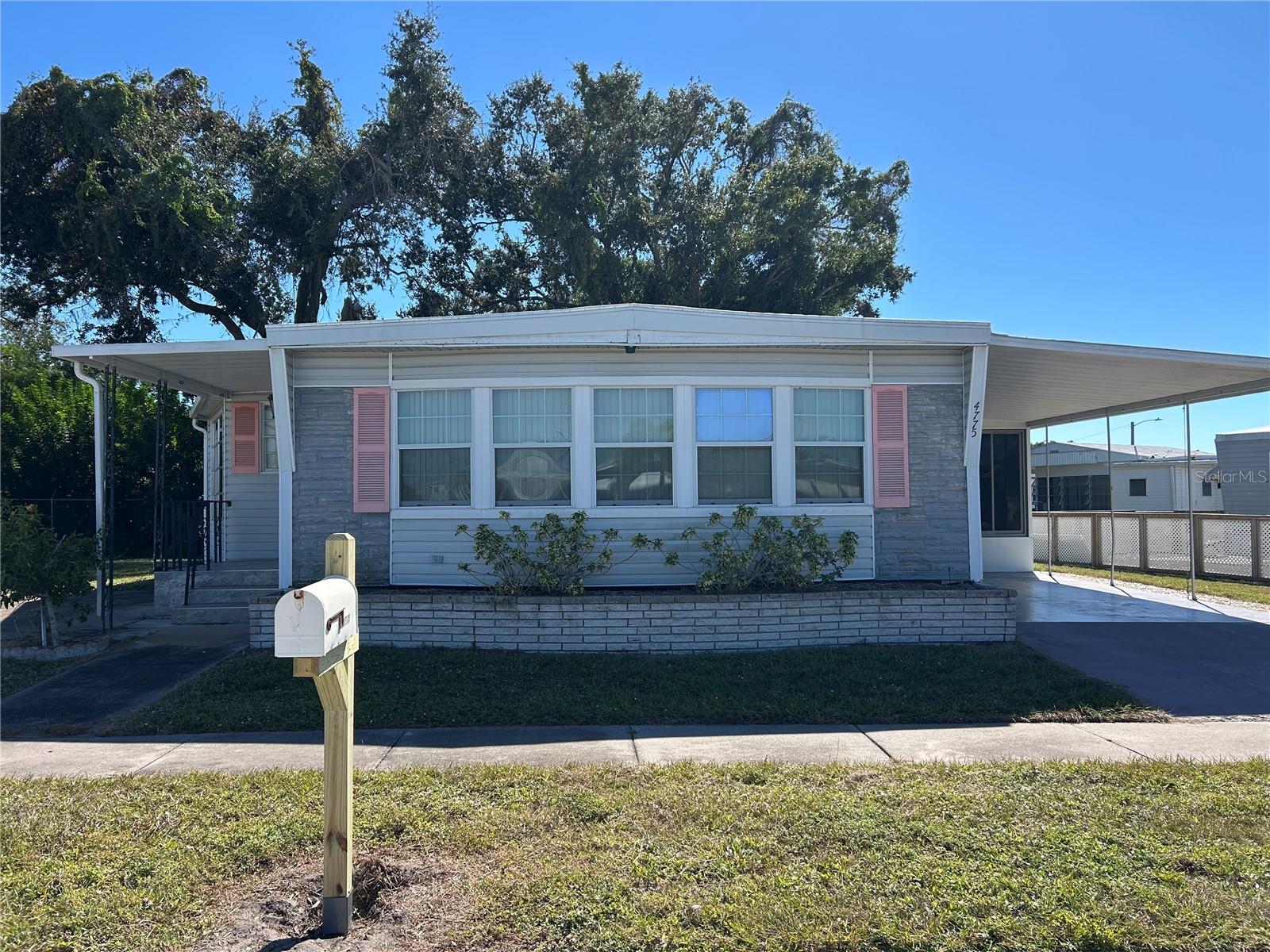 Checkout this handsome home ready for new owneers in popular Tri Par Estates! This property offers 1.5 lots - Unusually large lot. Offering 1100 square feet of living space, 2 bedroom, 2 bathroom, furniture included! Updates include 2025 new roof on the MH, some new flooring & ceiling updates in Living Rm, Dining Rm, Kitchen & Master Bedroom. Also includes 9 X 23 enclosed porch,  2nd parking pad, "golf cart is included" has not been run for 2 years+-. Large shed includes the W&D. This property is out of the flood zone code "X".  Tri-Par Estates is a 55+ community in which you own your home and the land. A park fee of $2,472.00 based on 1.5 lots. Tri Par dues are part of the property taxes paid once a year, includes Frontier internet, cable also trash. There is a large pool, hot tub, mini golf, laundry facilities, fitness room, clubhouse, and many activities to enjoy. Just minutes to the airport and many other like necessities nearby like hospitals, shopping, restaurants and more. Please do not disturb resident. Airplanes & jets do fly over Tri Par Estates. Tri Par is a state park & recreation development.