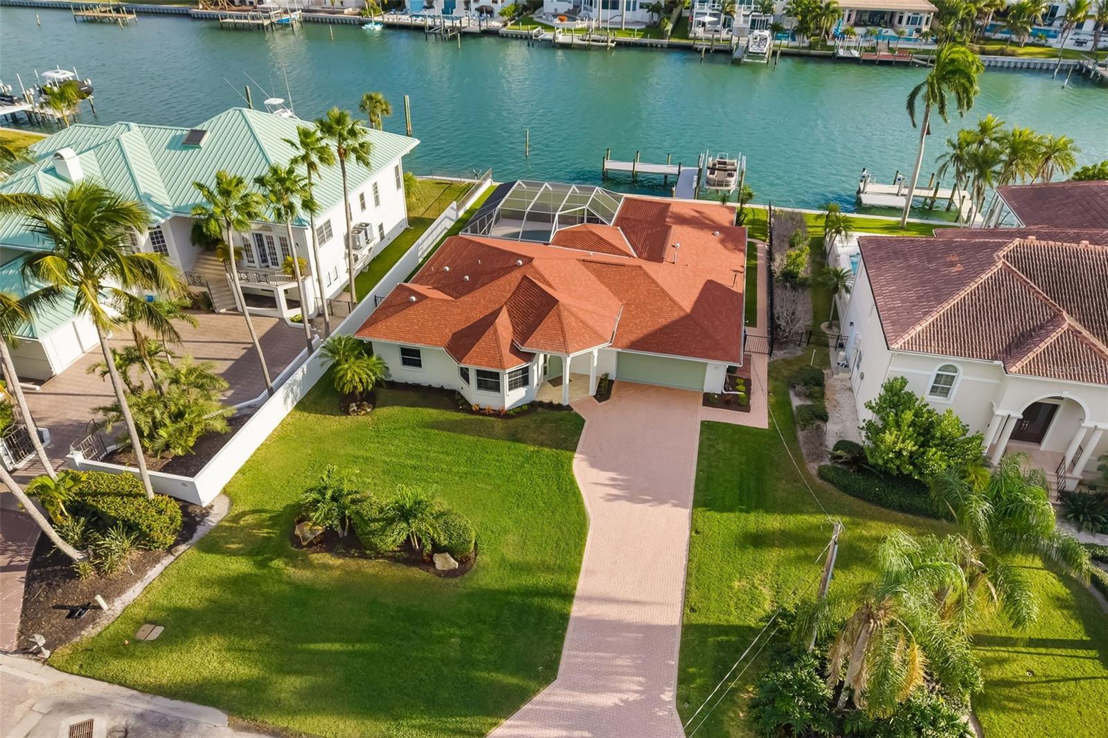 Under contract-accepting backup offers. Experience the ultimate in coastal luxury with this exceptional waterfront residence on Lido Key. Perfectly positioned along a wide, private deep-water canal, this beautifully renovated 3-bedroom, 3.5-bath home offers direct, bridge-free boating access to the Intracoastal Waterway and the Gulf of Mexico—an extraordinary feature for boating enthusiasts.
Just two blocks from pristine Lido Beach and within walking distance to the vibrant shops and restaurants of St. Armands Circle, this home combines an unbeatable location with a serene, private setting.
Designed to maximize its stunning waterfront surroundings, the home features expansive living spaces with six sets of sliding glass doors that seamlessly blend indoor and outdoor living. Step outside to a screened-in, south-facing heated pool and spacious paver deck—ideal for entertaining or simply relaxing while enjoying tranquil canal views. The private dock 2024 is fully equipped with a lift, power, and water, making it effortless to get out on the water at a moment’s notice. Lift can take 12,000 pounds. 
Inside, the home has been completely renovated in 2025 with a focus on modern elegance and functionality. The kitchen showcases stainless steel appliances, a built-in microwave, floating shelves, and ample cabinetry, along with a conveniently located pantry adjacent to the laundry room with utility sink. Porcelain tile flooring runs throughout, enhancing the home’s clean, sophisticated aesthetic.
A thoughtfully designed layout offers both comfort and flexibility. A front-facing guest suite provides privacy for visitors, while a light-filled office or den—framed by three bay windows and enclosed with French doors—serves as an ideal workspace or additional living area. The primary suite is a private retreat featuring custom dual closets and a spa-inspired bathroom with floor-to-ceiling tile, glass-enclosed shower, and plantation shutters. A stylish half bath adds convenience for guests. Rental Projections avail. Investment Opportunity.
Offered fully furnished, this home is truly move-in ready and designed for effortless coastal living. Enjoy quiet, walkable streets, nearby nature trails, and easy access to downtown Sarasota via the Ringling Bridge, where world-class dining, arts, and culture await.
This is a rare opportunity to own a turnkey waterfront sanctuary in one of Sarasota’s most coveted island communities—where luxury, location, and lifestyle come together seamlessly. Walk to Lido Beach and catch a Sunset Or take the boat!