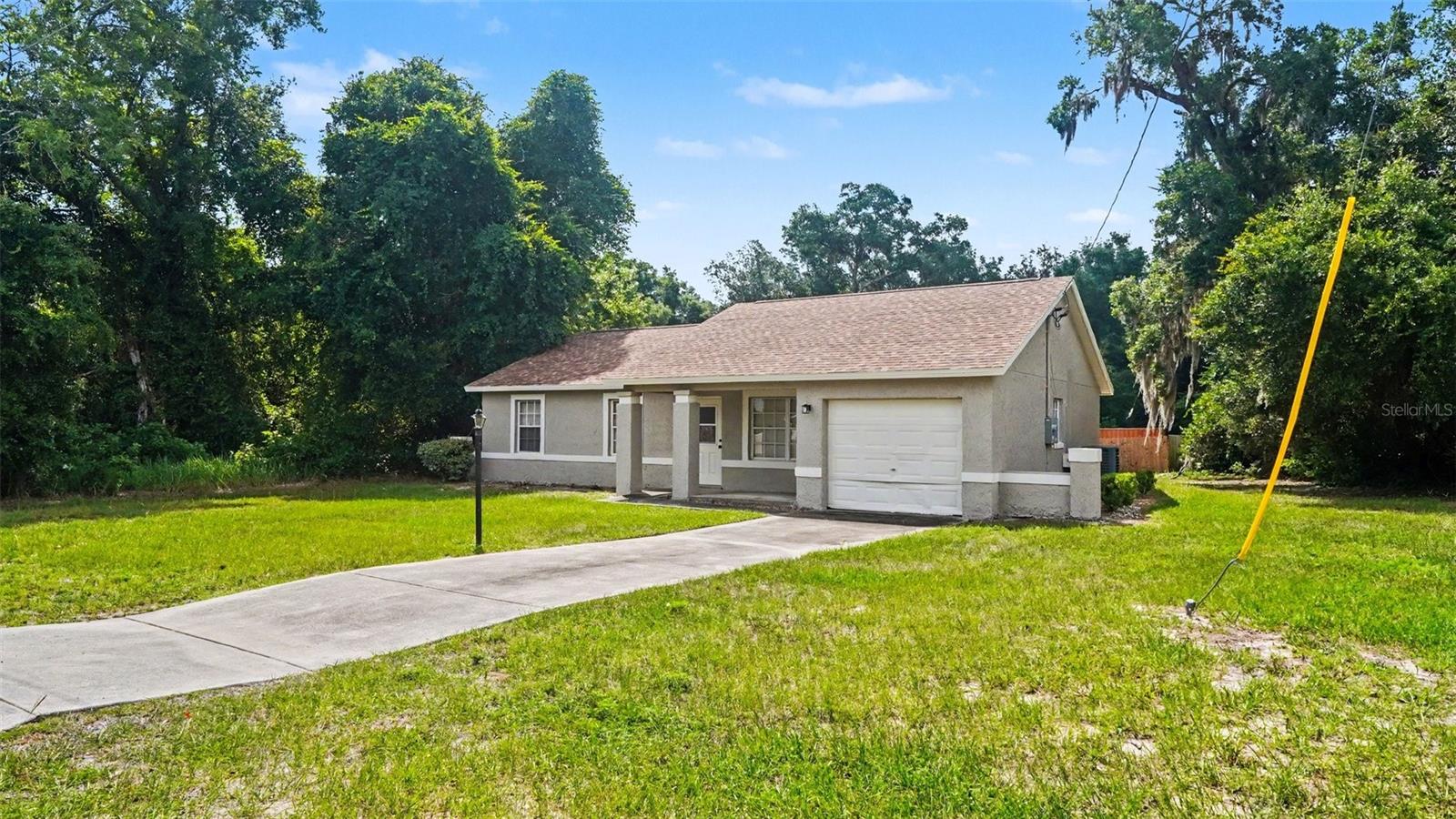 Virtually Staged. Move-in ready, this 3-bedroom, 2-bathroom home in the desirable Silver Springs Shores community sits on a spacious 0.31-acre lot and offers 1,128 sq ft of comfortable living space.  The roof was replaced in 2022, and a brand-new water heater (2026). Inside, the kitchen and bathrooms feature durable, easy-care LVP (luxury vinyl plank) flooring, while all three bedrooms have the carpet . A single-car garage provides convenient parking and extra storage. The home's functional floor plan is well suited to first-time buyers, those looking to down size, or investors looking for a low-maintenance property with plenty of room to spread out on the generous lot.
Located in Silver Springs Shores, the home offers easy access to SE Maricamp Rd, with convenient proximity to Belleview, The Villages, and Lockheed Martin — a great spot for commuters, plus easy reach to Ocala's springs, trails, and equestrian country.