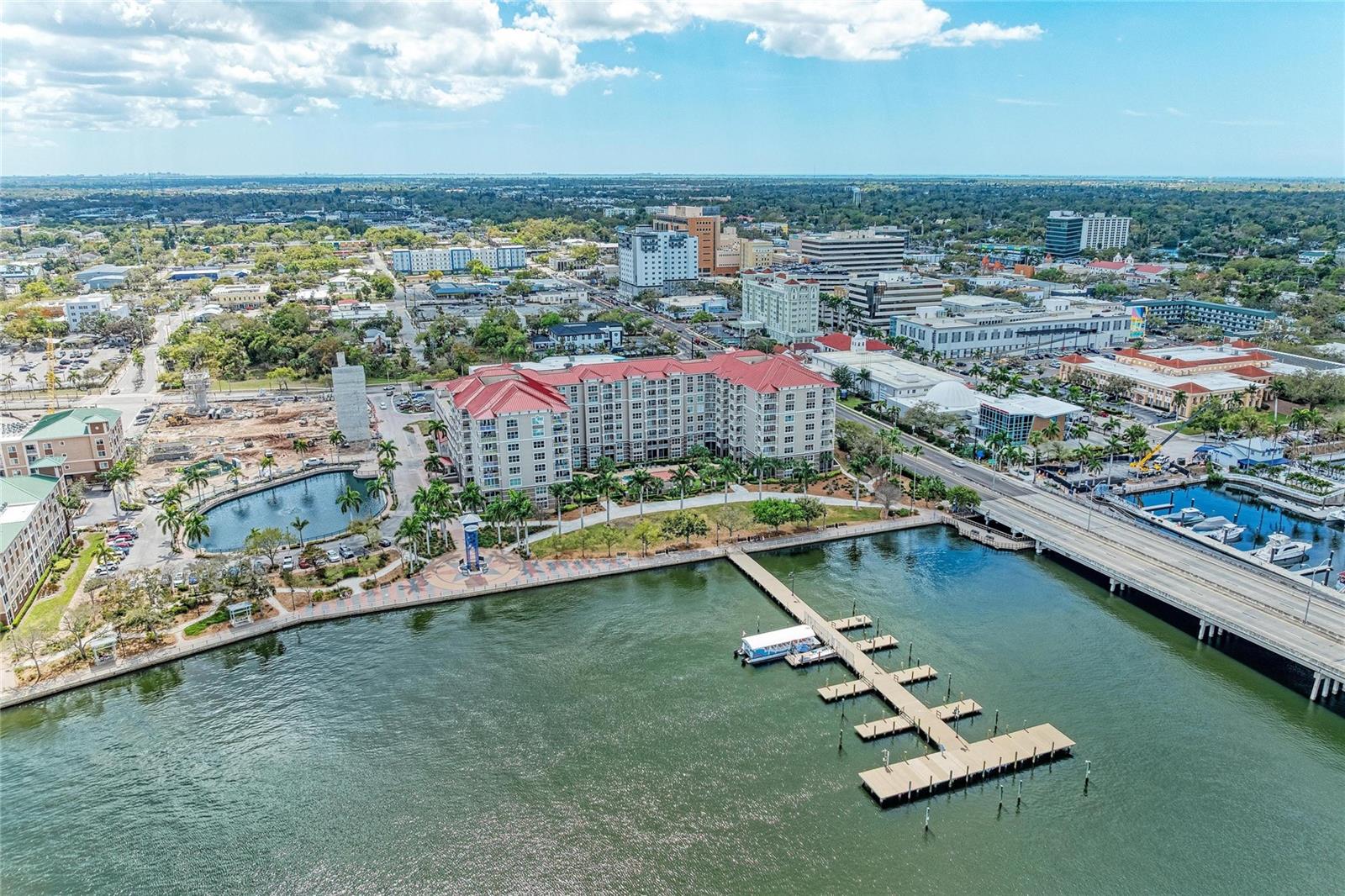 Imagine evenings on your private balcony with peaceful pool views and a sunset glow over the Manatee River. Set in a beautiful park-like setting along the scenic Riverwalk, this 2-bed, 2-bath, furnished 1,514-SF residence offers a rare blend of waterfront living and walkable access to downtown Bradenton’s restaurants, shops, cultural venues, and marinas. The Anna Maria Island Ferry docks just outside the community, giving you a scenic, care-free route to the island’s beaches.  Inside, an open layout seamlessly connects the  kitchen (with granite counters) to the dining and living areas. The spacious primary suite features a walk-in closet and a spa-like bath with a garden tub, shower, double sink vanity, linen closet, and private water closet with a Toto bidet seat. A split floor plan places the guest bedroom and bath on the opposite side for added privacy. Recent upgrades include impact windows, newer carpeting in the bedrooms, and  A/C unit replaced 11/2024.  River Dance residents enjoy secured entry, on-site management, and an impressive list of amenities: heated pool and spa, tennis and pickleball courts, basketball court, theatre room, 6-hole putting green, club and game rooms, fitness center with rooftop jogging track, business center with conference room, and two rentable guest suites. Waterfront walking paths  and river views enhance your Downtown lifestyle.