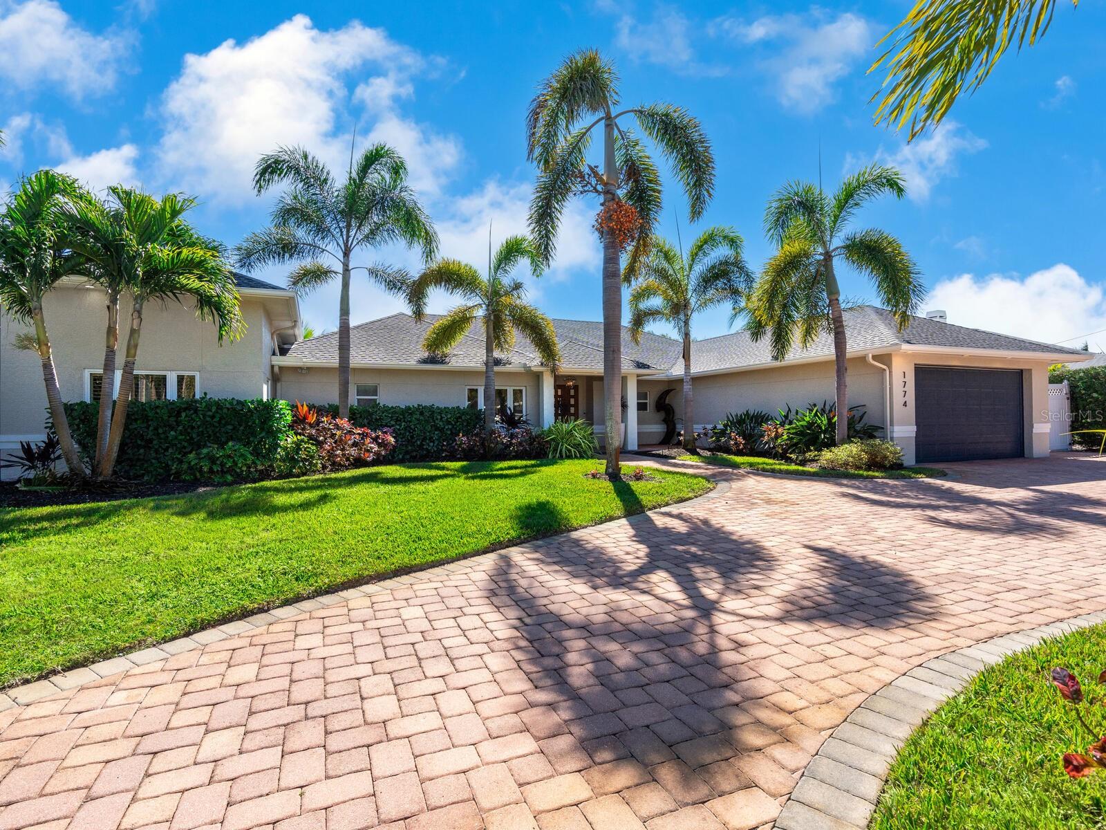 Welcome to waterfront luxury living at its finest! Nestled at 1774 Meadowood Street in Sarasota, Florida, this magnificent home offers the epitome of mainland living on deep boating water, with no bridges to the Bay and the Intracoastal Waterway. Boasting proximity to the world-famous Siesta Beach, this residence is the ultimate retreat for those who crave both elegance and adventure. As you step through the spectacular entry doors and into the foyer, you'll be greeted by an open-concept floor plan designed to seamlessly blend indoor and outdoor living. Walls of sliding glass doors flood the space with natural light, inviting the lush outdoors in and extending the living area to the backyard oasis. Whether you're lounging by the private pool, relaxing in the spa or cooking in the outdoor kitchen, every moment is a celebration of luxury and comfort. The heart of this home lies in its fabulous kitchen, featuring wood cabinetry, stone countertops and stainless steel appliances, including a Wolf gas range and Sub-Zero refrigerator. The great room floor plan, dining area and kitchen effortlessly flow together, creating an ideal space for entertaining family and friends. Retreat to the primary bedroom suite, a haven of relaxation boasting a sitting room, multiple walk-in closets, a luxurious bathroom and a private patio overlooking the serene surroundings. Two guest rooms with en-suite baths, an additional full bath and a convenient laundry room ensure ample space for all. Outside, the spectacular gardens lead to the waterfront yard, complete with a dock and a 7,000-pound boat lift. Fish from the dock, paddleboard, kayak or embark on a sunset cruise — all just moments away from the open waters of the bay. With a circular drive, newer roof (2019) and updated dock and seawall cap (2019), this home is as functional as it is stunning. Experience the best of mainland living just minutes from Siesta Key's renowned quartz sand beaches and a short drive from downtown Sarasota's vibrant restaurants, shopping and cultural amenities. Don't miss your chance to own a piece of paradise in this prime Sarasota location — schedule your private showing today and make your waterfront dreams a reality!