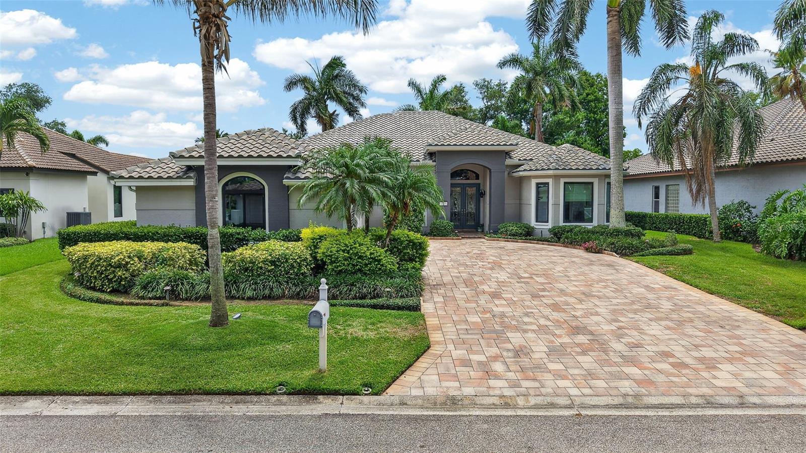 Welcome to an extraordinary waterfront retreat in the coveted 24-hour guard-gated community of Placido Bayou. Custom-crafted and impeccably maintained, this stunning single-story residence seamlessly blends timeless design, luxury amenities, and exceptional boating access. Constructed of solid block and thoughtfully updated, the home features four bedrooms, three baths, a concrete tile roof (2019), Generac whole-house generator, solar panel system (seller owned), dual Trane HVAC systems with dehumidifiers, a three-car garage (with 220-volt outlet for EV car charging), and a screened pool enclosure designed for year-round enjoyment. Boating enthusiasts will appreciate the exceptional composite dock, complete with an extremely rare, covered boathouse, 10,000-pound lift, kayak launch, water and electric service, concrete-anchored pilings, and direct access to Tampa Bay. Inside, an elegant open-concept floor plan unfolds around the resort-style pool terrace, creating seamless indoor-outdoor living. Soaring vaulted ceilings, abundant natural light, and formal living and dining spaces provide both comfort and sophistication. The deluxe chef's kitchen is beautifully appointed with new marble countertops, stainless steel appliances, wine fridge, a walk-in pantry, breakfast nook, bar seating, and a private office corridor ideal for working from home. The luxurious owner's retreat serves as a private sanctuary, featuring a spacious sitting area, spa-inspired bath, and French doors that open directly to the pool and lanai. Additional enhancements include a premium surround-sound system that extends throughout both the interior and outdoor entertaining areas. Designed for effortless entertaining, the screened lanai showcases a sparkling PebbleTec saltwater pool and spa with propane heat, wet bar, dining space, and multiple lounging areas surrounded by lush tropical landscaping. Beyond the pool, a fenced backyard and winding paver pathways lead to the waterfront, creating a private oasis for family, guests, and pets alike. Residents of Placido Bayou enjoy a serene, nature-filled setting with miles of scenic walking and jogging paths, tranquil lakes, abundant wildlife, and 24-hour guarded security. Ideally located just minutes from downtown St. Petersburg, top-rated schools, the Racquet Club of St. Petersburg, the vibrant 4th Street corridor, I-275, and the Gandy Bridge, this exceptional waterfront property offers the perfect balance of privacy, convenience, and the ultimate Florida lifestyle. Seller is performing whole home inspection and will provide buyer with clean 4 Point and Wind Mitigation report for additional peace of mind. Buyer to verify all measurements, HOA, and community regulations and information.