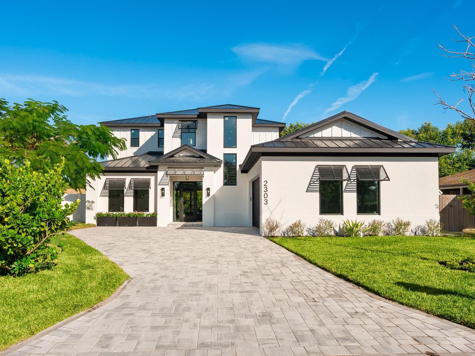 Fantastic $100,000 price reduction!!! In the well-established Loma Linda Park neighborhood in Sarasota, this new construction, Divald Homes custom-built two-story home offers a blend of modern design and traditional elements. The home is ideally near downtown Sarasota, Siesta Key and Sarasota Memorial Hospital, with no deed restrictions or HOA fees. The home features four bedrooms and three baths, including a spacious primary suite on the main floor. The open-concept floor plan featuring a 24-by-48-inch modern floor tile throughout, hurricane impact sliding doors and  windows offers a light-filled welcoming space ideal for entertaining. The main floor includes a gourmet kitchen, dining area, living room, private den/bedroom 4, primary suite with an ensuite bath and a dedicated laundry room. The chef’s kitchen is a centerpiece, showcasing Bosch appliances, an oversized island with waterfall quartz countertop, and custom floor-to-ceiling full-overlay cabinetry in a beautiful honey-stained wood tone. The living room is highlighted by a striking tile accent wall with custom wood shelving and modern designed 42-inch linear electric fireplace. The living room opens seamlessly to the lanai, complete with an outdoor kitchen, including a gas grill, refrigerator and sink. You will also enjoy the pool with sundeck, oversized outdoor patio and a beautiful backyard with lush native plantings. A convenient pool bath offers direct access from the lanai and the private den. The dining area is elegant and inviting, featuring a statement iron chandelier and a wall of windows overlooking the backyard. Just off the kitchen, the main-floor primary suite serves as a private retreat with a luxurious en-suite bath featuring a marble stone accent wall, a large walk-in shower with seamless glass enclosure, a sculptural slipper tub, double vanity with quartz countertops, natural wood cabinetry, LED mirrors and a spacious walk-in closet with custom built-ins. The laundry room is conveniently near the oversized two-car garage with 12-foot ceilings, large windows for natural light and direct access to the side yard. Upstairs, an ornate wrought-iron and hardwood staircase leads to two additional bedrooms, a beautifully finished guest bath and a versatile flex room ideal for a game room, study or guest accommodations. This thoughtfully designed home offers refined finishes, flexible living spaces and an exceptional location, ideal for enjoying the Sarasota lifestyle.