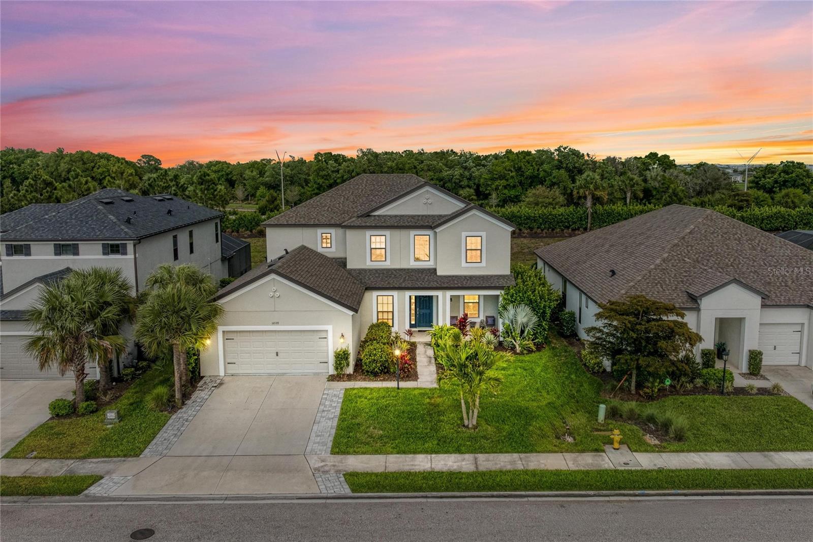 Welcome to your private oasis in the highly sought-after Park East at Azario! This stunning 5-bedroom, 4-bathroom pool home perfectly blends luxury and comfort within the heart of Lakewood Ranch. As you step inside, you are greeted by an expansive open floor plan that seamlessly connects the living area and kitchen, creating an ideal environment for entertaining. The living room features an elegant coffered ceiling, while the tray ceiling adds a touch of architectural flair to the space. Beautiful tile flooring spans the main living areas, leading to a gourmet kitchen complete with crisp white cabinetry and modern finishes.

The primary suite serves as a true retreat, boasting a spacious walk-in closet and a spa-like ensuite bathroom equipped with a walk-in shower and a relaxing garden tub. Upstairs, you will find a versatile family area and cozy bedrooms featuring plush carpeting. Ceiling fans are installed throughout the home to ensure year-round comfort. Outdoor living is elevated to the next level with a 2-car garage and a screened-in lanai that houses a sparkling pool and heated spa, all while enjoying a peaceful water view from the front of the home overlooking the community pond.

Beyond your front door, the Park East at Azario community offers a vibrant lifestyle with resort-style amenities including a community pool, volleyball and basketball courts, two dog parks, a sports field, and a playground.

Located in the world-renowned Lakewood Ranch, this property provides access to top-rated schools, including the brand-new Lake Manatee Elementary School opened for the 2025-2026 school year. Enjoy being just minutes away from premier shopping, fine dining, and world-class golf courses. With quick access to I-75, you are perfectly positioned to reach Lakewood Ranch Main Street, Waterside, and the breathtaking Gulf Coast beaches in no time. Schedule your private showing today to experience this dream home for yourself! Zoned for the New Lake Manatee k-8 school!!