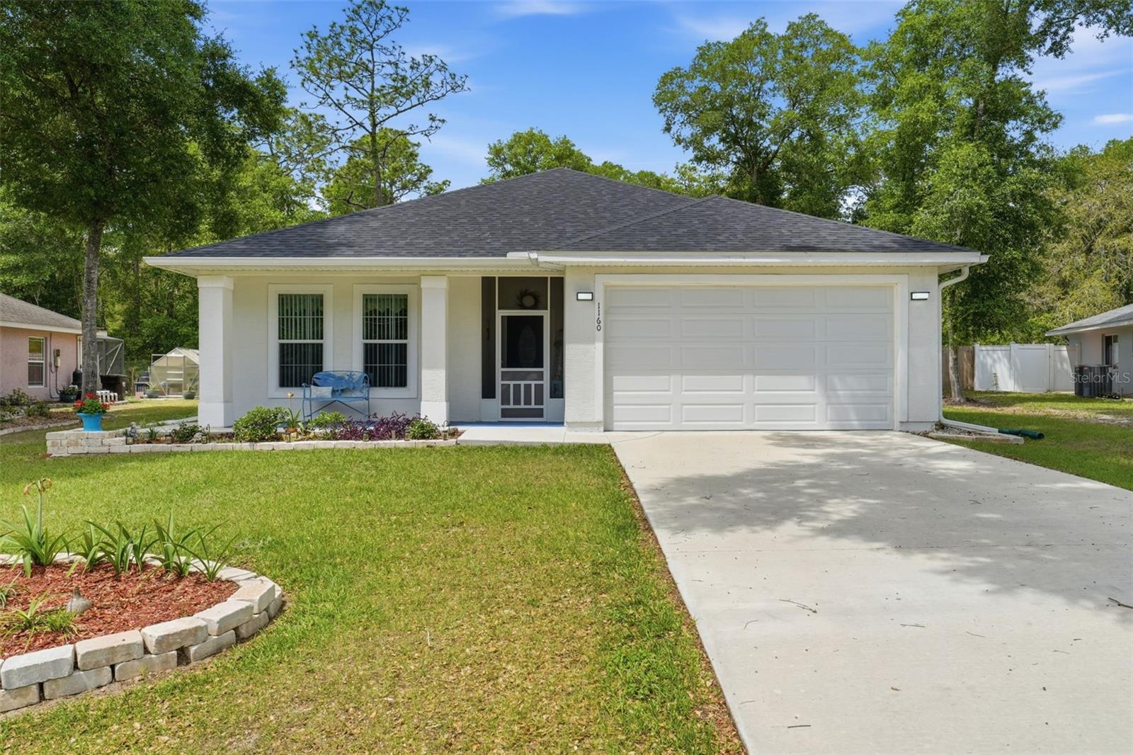 Calling all nature lovers!!! Charming home nestled in a quiet gated community, with the Ocala National Forest as your back yard neighbor. ***Sellers are offering a one year rate buy down***Built in 2024, this beautifully designed two bed, two bath residence with a dedicated office offers the perfect blend of rustic Florida charm and modern convience. Step inside to discover thoughtful upgrades throughout, including stylish lighting fixtures, custom cedar barn doors, ceiling fans, and a programmable thermostat for year-round comfort. In the kitchen find ample counter space and cabinets along with a butler's pantry and an island for casual dining. The spacious primary bath features a new vanity, toilet, and a cedar lined closet, adding both luxury and functionality. Enjoy peaceful mornings on the front porch, or unwind on your screened rear patio within a fully fenced backyard, complete with fresh landscaping and a pergola covered gardening area, ideal for relaxing or entertaining.With serene forest views and modern touches throughout, this home is a retreat in a natural setting. The community offers a covered pavilion, BBQ grills, kayaking, or paddleboarding on Lake Waldena, and RV/boat storage. Welcome home!!!