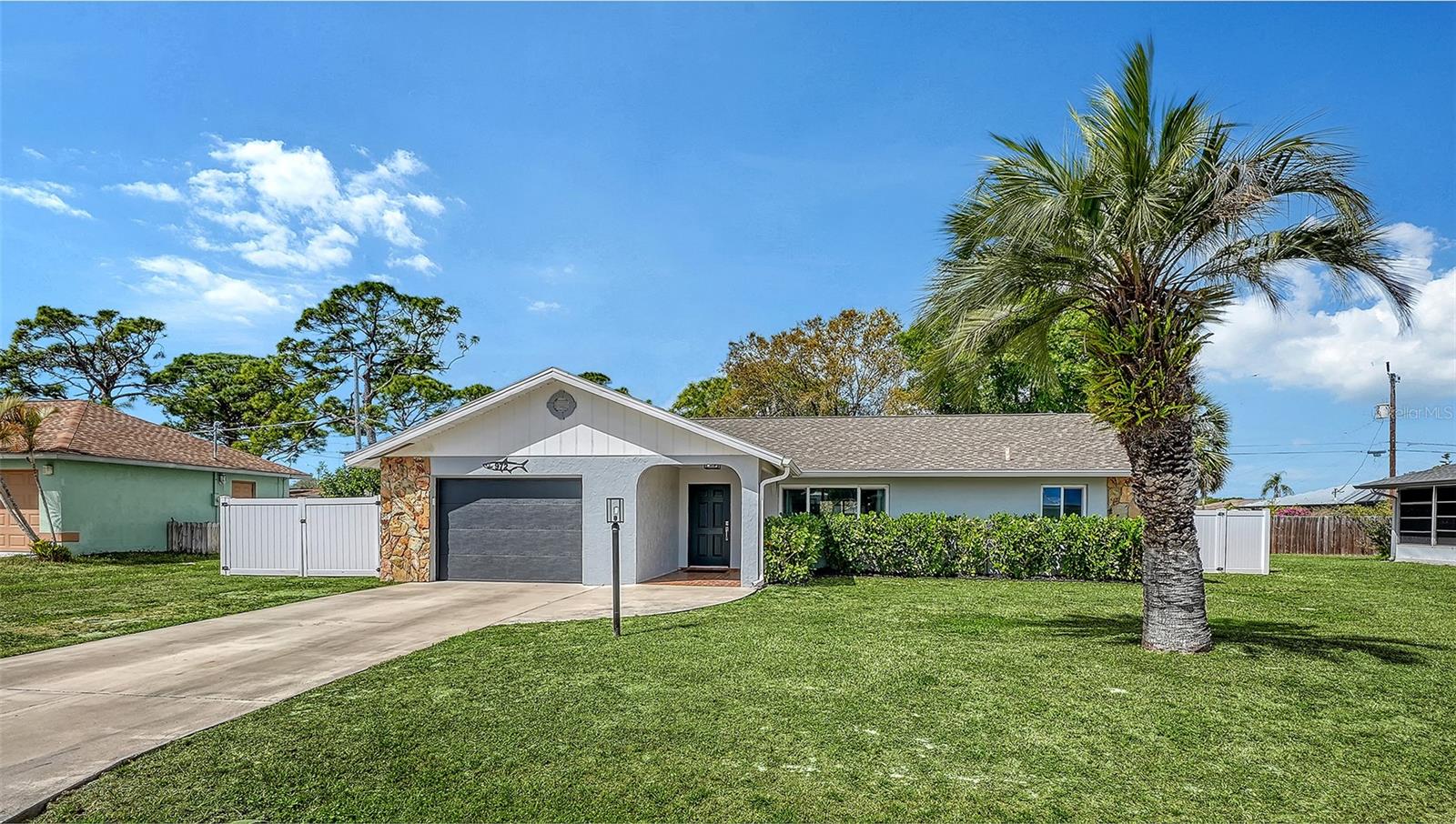 Move-in ready in South Venice! This light and bright 2-bedroom, 2-bath home offers comfortable Florida living with a thoughtful layout and inviting spaces throughout. The kitchen features shaker-style cabinetry, stainless steel appliances, a tile backsplash, and a convenient pantry closet. The spacious primary suite includes a very large walk-in closet, en-suite bath, and sliding doors that open to the lanai—perfect for enjoying your morning coffee or relaxing in the evening. Step outside to a spacious, fully fenced backyard with plenty of room for pets, gardening, or outdoor gatherings. Major updates provide peace of mind, including a full home replumb and new water heater in 2024, along with new well tanks and pumps in 2025. All windows and doors are impact-rated, including the garage door. Additional highlights include an oversized one-car garage with epoxy floors and underground power lines coming soon to the neighborhood.