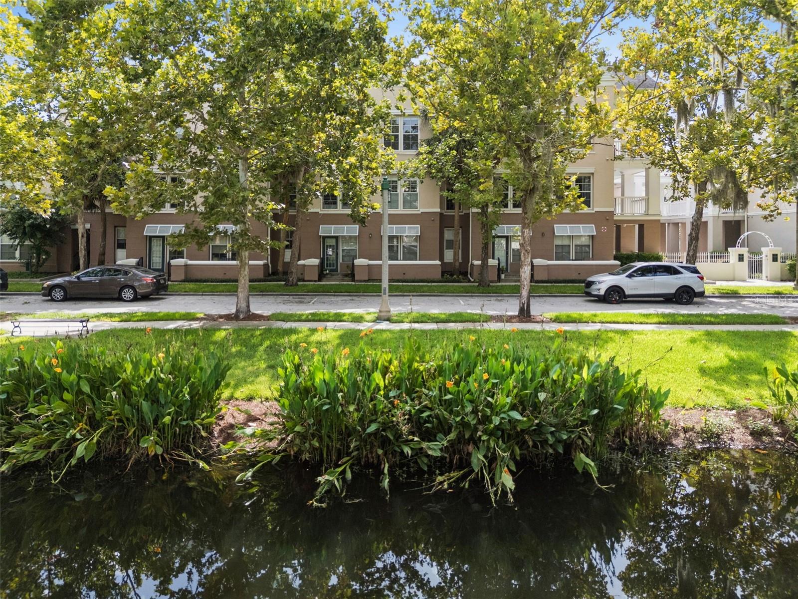 Experience the best of Celebration living in this beautifully updated top-floor condo overlooking the picturesque Water Street Canal. Perfectly positioned in the heart of Downtown Celebration, this move-in ready residence combines timeless charm, modern upgrades, and an unbeatable location just steps from everything this award-winning community has to offer. Inside, you'll find a thoughtfully redesigned kitchen featuring quartz countertops, stainless steel appliances, ceramic tile flooring, and an open, inviting layout that's perfect for everyday living and entertaining. Elegant smoked glass interior doors, crown molding, upgraded baseboards, custom window casings, stylish blinds, new light fixtures, ceiling fans, and beautiful new carpeting add sophistication throughout the home. The fully remodeled bathroom offers a fresh, contemporary design, newer water heater and the 2014 HVAC replacement provides added peace of mind. Floor-to-ceiling windows fill the living room, dining area, and bedroom with natural light while framing tranquil views of mature trees and the scenic Water Street Canal, creating a peaceful retreat in the center of town. Living in Downtown Celebration means enjoying one of Central Florida's most sought-after lifestyles. Just outside your door, you'll discover an exceptional collection of restaurants, coffee shops, boutiques, salons, banks, and medical offices, all connected by beautifully landscaped streets and miles of walking and biking trails. Residents enjoy year-round community events, farmers markets, seasonal festivals, lakeside parks, tennis and pickleball courts, playgrounds, dog park, and multiple community pools. Ideally located just minutes from Walt Disney World Resort, AdventHealth Celebration, major highways, Orlando International Airport, and Central Florida's world-famous attractions, Celebration also offers convenient access to championship golf, premier shopping, dining, and entertainment. Whether you're searching for a full-time residence, seasonal getaway, or investment opportunity, this immaculate canal-view condo offers the perfect combination of location, style, and the distinctive Celebration lifestyle.