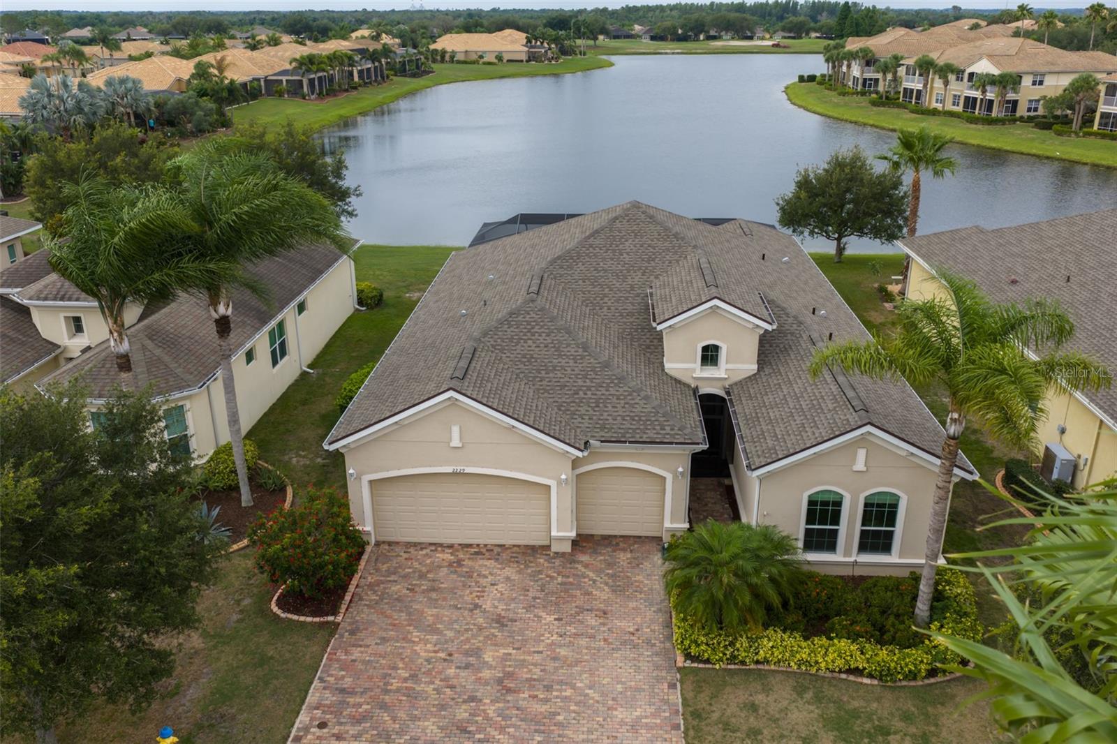 Virtually Staged. ***Click on 3D Tour Above***
A RARE GEM ------ BEAUTIFUL 3 BEDROOM, 3 FULL BATHROOMS, DEN/OFFICE, PLUS 3 CAR GARAGE, IMPACT WINDOWS & PREMIUM WATER VIEW LOT!  Reward yourself with retirement living at its finest in the premier 55+ resort-style community of Renaissance in Sun City Center, FL.  This gorgeous "NEWPORT" model offers a modern open floorplan w/almost 2500 sq ft of functional living area w/no wasted space.  Enter through the grand foyer and be wowed by the "wood look" ceramic tile flooring throughout, soaring high tray ceilings, arched doorways, neutral decor and TERRIFIC WATER VIEWS ALL ACROSS THE REAR OF THE HOME.  The fabulous light & bright eat-in kitchen has 42 inch ivory wood cabinetry w/pullouts, granite counters, stainless appliances including a double wall oven and a huge island, all overlooking the great room.  The comfortable great room is the perfect space for entertaining and has a wall of sliders leading out to the lanai area.  For an added bonus, this home has 2 PRIVATE BEDROOM SUITES, both with ample closet space and luxurious ensuite bathrooms with granite counters & walk-in showers.  This home also has a 3RD BEDROOM & FULL BATHROOM for extra comfort & privacy when family & friends visit.  Need extra space for your office or hobbies? This home has a designated 10 x 11 versatile room with pretty glassed doors.  When you want to relax & enjoy the serene & peaceful water views, retreat to the EXTENDED, COVERED & SCREENED LANAI W/OUTDOOR KITCHEN, where you can lounge all day long.  Other recent upgrades are NEW ROOF 2025, LANAI RE-SCREENED 2025 & GENERATOR 2021.  This home also comes with a 1 YEAR HOME WARRANTY for worry free living.  The home is just a short walk or golf cart ride to the neighborhood Club Renaissance where you can enjoy dining, drinks, social activities, resort-style pool, fitness classes, spa, and so much more.  You'll also have access to all Sun City Center amenities such as shopping, restaurants, banking, doctors, numerous social & sports clubs, and much.  So come and visit this beauty today and see why you'll want to call it yours!