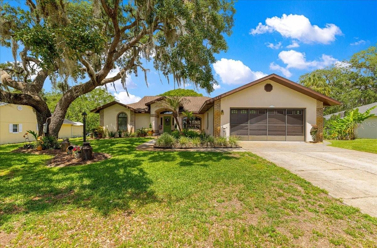 This 3 bedroom 2 bath home sits on over a half acre with fresh water canal along the back. Pulling up you will immediately notice the pretty yard with mature landscaping. Inside you can see the love the homeowner has for the home. Enter into your living room with French doors going to the screen enclosed lanai with views of your large backyard and gazebo leading to the canal. The kitchen has plenty of cabinet space for storage, stainless steel appliances and a nook. There is a formal dining room. The primary bedroom has wood look flooring and the bath includes a jetted tub, step in shower along with a walk-in closet. Part of the garage has been converted into a hobby/game room with heat and air. In the garage there is a water softener and iron zapper. Roof was replaced in 2012 and HVAC in 2023. The canal has a small dock and leads out to Lake Henderson and the chain of lakes. Call for your appointment to see today!