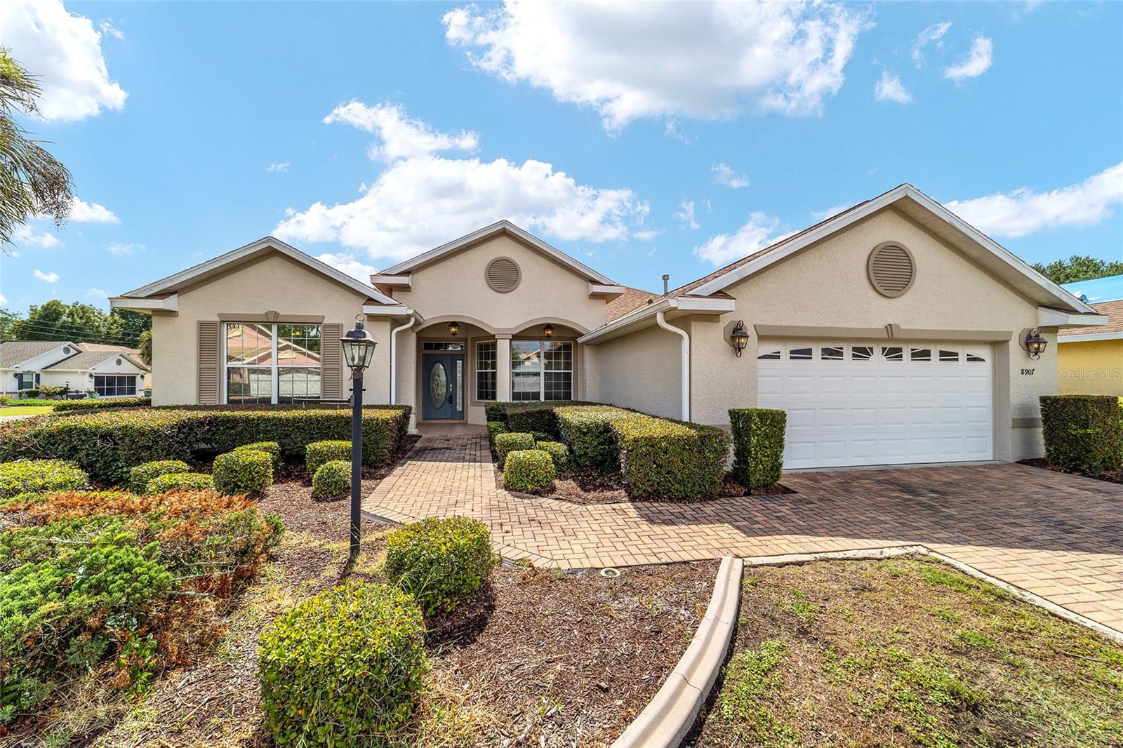 Affordable luxury awaits in this move-in ready Ayreshire located in the sought-after Candler Hills neighborhood of On Top of the World. 
Nestled on an almost 1/3-acre corner lot at the entrance of a cul-de-sac, this 3-bedroom, 2-bath home offers both privacy and space in one of 
Ocala's premier 55+ communities. The thoughtfully designed split-bedroom floor plan features a spacious primary suite with two walk-in 
closets and an ensuite bath complete with dual vanities, a private water closet, and a large walk-in shower with built-in bench seating. The 
kitchen is equipped with solid oak cabinetry, solid surface countertops, and stainless steel appliances, providing both functionality and 
timeless appeal. 
Luxury vinyl plank flooring and crown molding throughout the main living areas add a refined touch, while plush carpeting in the 
bedrooms creates a warm and comfortable retreat. Major updates include a new roof (2024), HVAC system (2018), and water heater (2019), 
offering peace of mind for years to come. 
The oversized garage easily accommodates two vehicles plus a golf cart. Outside, the fully sodded and irrigated lawn, paver driveway, and 
expansive corner homesite provide excellent curb appeal. 
Residents of Candler Hills enjoy curbside mail delivery and waste collection, along with exclusive neighborhood amenities and full access 
to the extensive amenities of On Top of the World. Ocala's premier 55+ resort-style golf community offers golf cart access to shopping, 
dining, entertainment, banking, healthcare, and beauty services, creating a lifestyle that is both active and convenient.