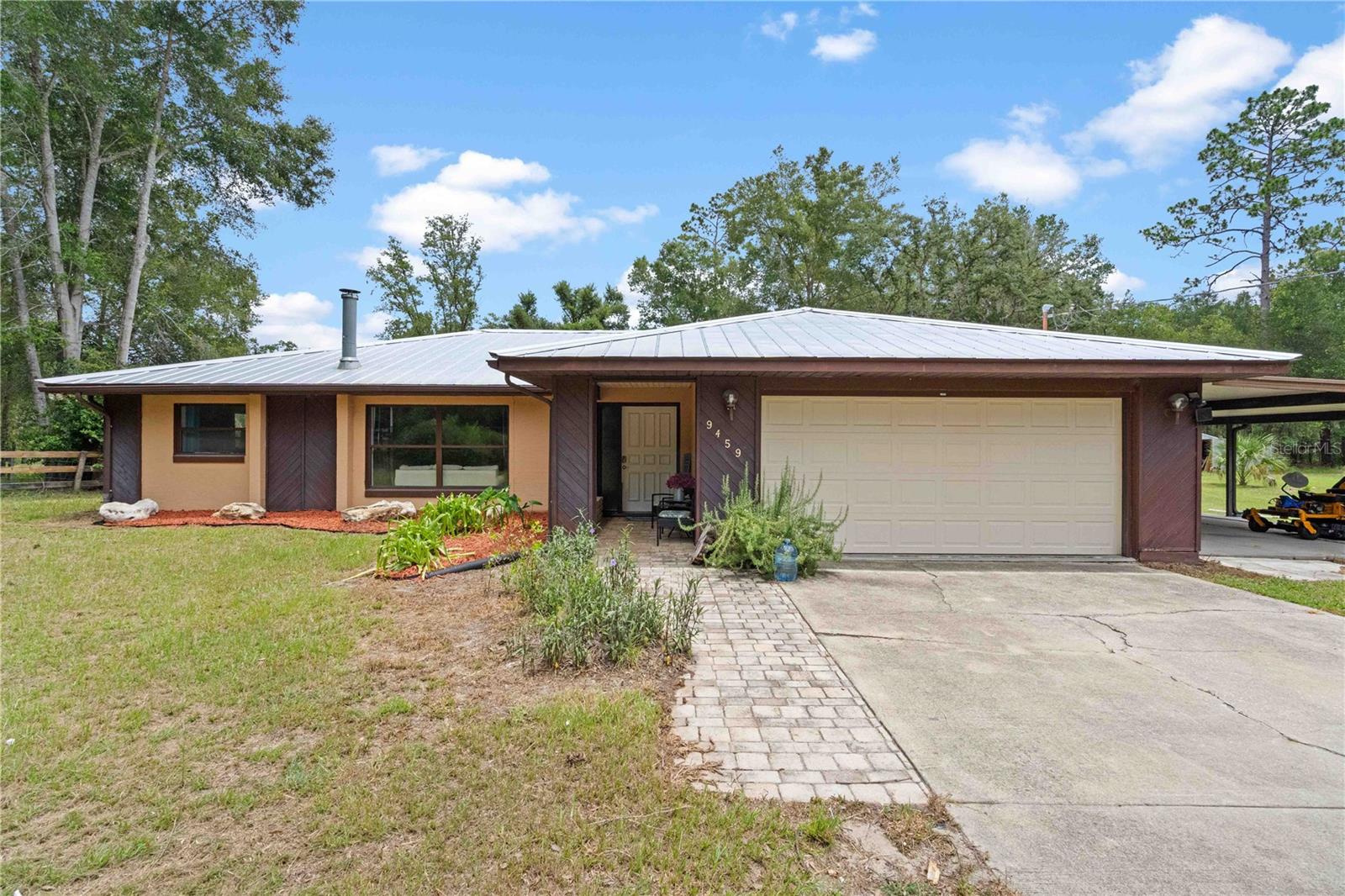 Modern Country Living with Pool on 2.52 Acres! Welcome home to this beautifully updated 3 bedroom, 2 bath concrete block home tucked away at the end of a quiet dead-end street on the outskirts of Dunnellon. Offering over 1,900 square feet of living space, this home features an open-concept floor plan with a spacious island kitchen that flows seamlessly into the living and dining areas—perfect for entertaining family and friends. Step outside to your own private retreat where a screened-in pool and outdoor kitchen create the ideal setting for year-round enjoyment. The luxurious primary suite offers a relaxing escape, while abundant storage, tile flooring throughout, and modern updated finishes provide comfort and easy maintenance.
Outside you'll find plenty of room for your hobbies and animals with a two-car garage, carport, storage shed, small barn with room for a couple of stalls, and two turnout paddocks—all situated on 2.52 beautiful acres.
Enjoy the peace and privacy of country living while still being just a short drive from shopping, restaurants, schools, and the natural beauty of the Rainbow Springs and Crystal River area. Don't miss this opportunity to own your own slice of Florida paradise!