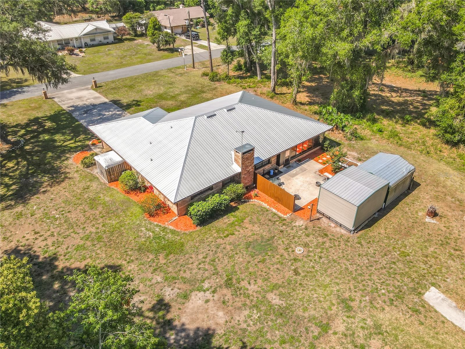 Welcome to your perfect home in small golf cart community with NO HOA and private beach and lake access! This solid 3/2 brick home on oversized lot allows you the FREEDOM to truly make this property your own! Enjoy piece of mind with a whole house generator, two newer A/C units with HALO air cleaner, metal roof, spray foam insulation, sec cameras, alarm, multi zone sprinkler system and gutters. Homes interior is nicely updated with newer flooring, fresh paint, granite countertops, new refrigerator, newer water heater and new washer & dryer. Nice floor plan with split bedrooms, seperate living room and dining room, wood burning fireplace in family room and even a dinette area off kitchen. Entertain or just relax on two beautiful covered porches, one in the front and a spacious enclosed porch on the back overlooking your future garden area, large walk in shed with electric and a seperate one car carport for tractor, toys or extra vehicle. Deeded lake access to S Twin Lake along with private beach area that is just around the corner-perfect for fishing, boating, kayaking or simply unwinding lakeside. Great school district and close to Ocala Forest, Alexander Springs and more. If you're looking for durability, efficiency in your next Florida home, this is it!