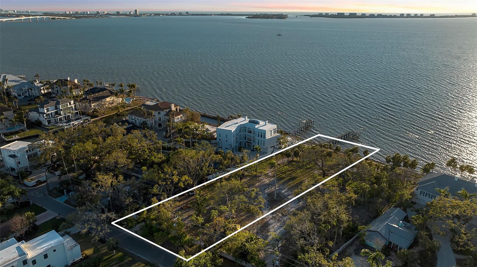 An extraordinary opportunity to build a world-class waterfront estate on Sarasota Bay. This rare direct bayfront vacant parcel at 2043 Alameda Way spans 38,009 SQFT with an impressive 104 feet of direct bay frontage, offering panoramic open water views, breathtaking sunsets, exceptional boating water, and a private dock already in place. Set within a quiet waterfront enclave, the property offers the ideal balance of privacy and convenience while remaining moments from Downtown Sarasota’s acclaimed dining, shopping, arts, and cultural attractions. Enjoy close proximity to the new The Bay Park, the renowned The John and Mable Ringling Museum of Art, and the convenience of Sarasota-Bradenton International Airport. Custom estate plans for the parcel have been designed by renowned Choeff Levy Fischman Architecture + Design, thoughtfully envisioning an exceptional luxury residence that maximizes the property’s scale, waterfront setting, and unobstructed bay views. Both parcels 2043 & 2046 Alameda Way are available for purchase together or separately, creating a rare opportunity for a buyer to secure a singular bayfront estate or assemble two significant waterfront properties totaling 1.7 acres with 210 feet of Sarasota Bay frontage. A truly exceptional offering combining scale, location, boating access, and limitless potential along one of Sarasota’s most coveted stretches of bayfront shoreline.