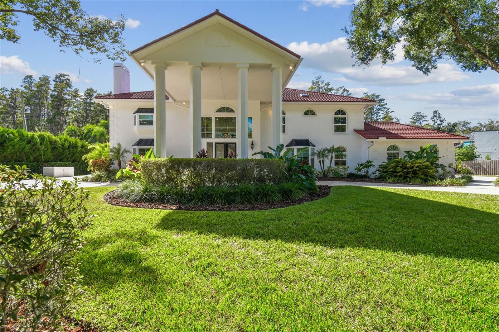 Welcome to your private lakeside retreat at 3505 Berger Road in Lutz, FL — an extraordinary 7-bedroom, 7-bathroom luxury custom-built estate offering 6,803 sq ft of fully remodeled living space, detached guest house, on a pristine 3.13-acre homesite along the peaceful shores of 33-acre Saddleback Lake. Set behind a private gated entrance, the property features a long, winding driveway surrounded by majestic live oak trees, meticulously manicured landscaping, and a full irrigation system—all fully fenced for ultimate privacy. With no HOA fees, this estate delivers unmatched freedom and elegance. Inside, the grand foyer welcomes you with soaring ceilings and an airy, open layout. The entire interior and exterior have been freshly painted, complementing the home’s modern waterproof laminate wood flooring, updated metal roof, and PGT impact windows and sliding glass doors throughout. The fully remodeled chef’s kitchen is a showpiece, featuring custom cabinetry, quartz countertops, soft-close drawers and doors, a large center island, breakfast bar, and top-of-the-line Thermador appliances. The expansive primary suite is a luxurious retreat offering two large walk-in closets with custom organization systems and a spa-inspired bathroom complete with dual vanities, quartz counters, a walk-in shower, stand-alone jacuzzi tub, private water closet, and high-end bidet. Each of the secondary bedrooms features its own en-suite bathroom with high-end finishes and a walk-in closet with custom storage. Detached guest house offers two bedrooms, a full kitchen, bathroom, private entrance, and dedicated parking—perfect for guests or multigenerational living. Step outside to the oversized screened-in pool and spa area, perfect for relaxing or entertaining, and enjoy peaceful lakefront living with your own private dock (replaced September 2025) ideal for fishing, kayaking, or taking in the serene views. The updated laundry room includes custom cabinetry and quartz counters, adding to the home's refined functionality. Located in a top-rated school district (Martinez Middle and Steinbrenner High) and just minutes from premier shopping, dining, and amenities, this gated lakefront estate offers an unparalleled combination of luxury, space, and lifestyle. Schedule your private tour today and experience the very best of lakeside living.