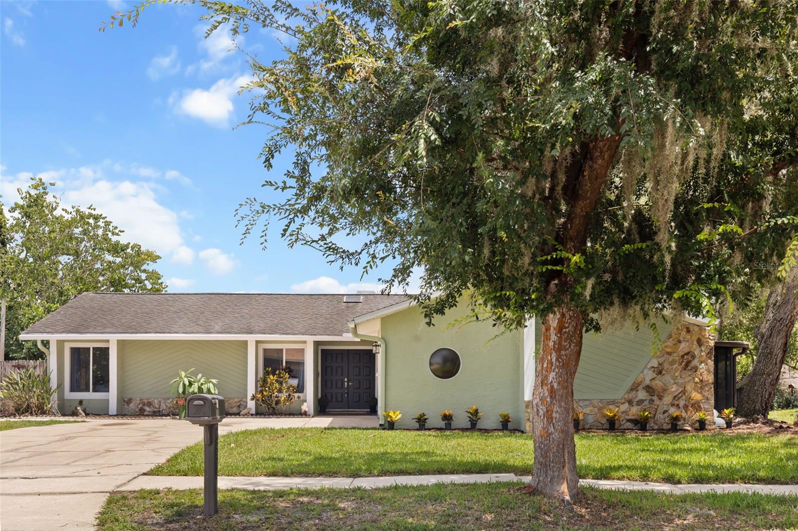 Introducing 12512 Willow Tree Ave. Reimagined, refined, and ready for its new homeowner! If you’re looking for a home with character and charm, with well thought out updates, this is the one for you! This beautifully updated single-story POOL HOME, perfectly situated on one of the LARGEST LOTS in the neighborhood! Nestled on 1.25 acres with no rear neighbors and backing to Shadow Lake, this property offers exceptional privacy while providing convenient access to SR-52, the Veterans Expressway, and US-19. Outdoor living is the true showstopper. Enjoy a large sparkling pool and an expansive screened, L-shaped lanai with MORE THAN 900 SQ FT OF COVERED OUTDOOR SPACE. Perfect for entertaining, relaxing, or enjoying Florida living year-round. The lanai concrete has been completely resurfaced (July 2026), and both the INTERIOR AND EXTERIOR of the home were FRESHLY PAINTED (June 2026), giving the property a fresh, move-in-ready feel. You’re greeted by incredible curb appeal with stone features, neutral, but such welcoming exterior colors, fresh landscaping, and a double front door. Inside, you'll find 3 bedrooms, 2 bathrooms, and a 2-car garage with an oversized driveway providing ample parking. There is absolutely NO CARPET throughout the home. One secondary bedroom features brand-new luxury vinyl plank flooring and a modern ceiling fan, while ceiling fans are installed throughout all bedrooms and the main living area for year-round comfort. The OPEN-CONCEPT FLOOR PLAN is filled with TON OF NATURAL LIGHT thanks to numerous windows, a triple sliding glass door, and French doors that seamlessly connect the living space to the lanai. The kitchen is designed for both everyday living and entertaining, featuring stainless steel appliances, a large center island with abundant bar seating, and a window over the sink overlooking the pool and lanai. The spacious primary suite offers direct access to the screened lanai, creating your own private retreat. The beautifully appointed primary bathroom features a beadboard and coffered ceiling, a relaxing soaking tub, a separate shower, and a large window that fills the space with natural light that makes you feel like you are on a beach retreat. The secondary bathroom is equally impressive with attractive tile work in the shower and an extended vanity offering generous counter space. With an INCREDIBLY LOW HOA of just $63 per year, this home combines privacy, space, and convenience. Enjoy being within an hour of some of Florida's most popular destinations, including Honeymoon Island, Howard Park, Weeki Wachee River, and Tampa International Airport. If you've been searching for a move-in-ready pool home with acreage, privacy, and an unbeatable outdoor living space, this exceptional property is ready to welcome you home.