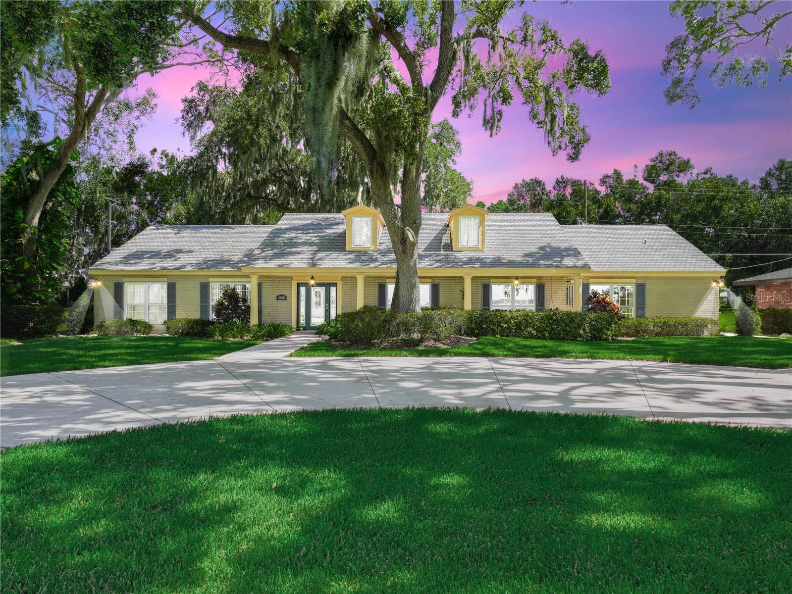 Located on Lake Ariana in Auburndale, this 4 bedroom, 2 bath Lakefront home has been completely updated and features beautiful upgrades and finishes.  Situated on a large lot snuggled under beautiful oak trees, you will enjoy relaxing on the sprawling front porch and taking in beautiful views of the lake.  The Gourmet Kitchen is a Chef's Dream featuring a Double Oven, Microwave, Cooktop, Refrigerator, Dishwasher, Range Hood, Pot Filler, beautiful Granite Countertops and Tile Backsplash.  The Large Kitchen also includes a Breakfast Bar and an additional Nook Displaying a Large Window that Allows Beautiful Sunlight to Stream In and Offers Great Views of the Lake.  To Add another bonus to this Fantastic Kitchen, there is the 13 x 8 Butler's Pantry Providing an Abundance of Space to Store Your Kitchen Tools and Supplies.   There is Plenty of Room to Entertain Dinner Guest in the Bright and Airy Dining Room Which Overlooks the Lake.  The Master Bedroom is Spacious and Features an Updated En Suite Bath that Includes a Large Walk-In Shower and Granite Countertops.  There are 3 Additional Bedrooms and Each Are Adequate in Size and Carpeted.  The 24 x 15 Bonus Room Is the Perfect Space for Family to Gather at the End of A long Day---Enjoy Playing Games, Watching Your Favorite Sports or TV Shows.  The 2 Car Garage Faces the Rear of the Home and has Additional Covered Parking, with Access from the Alley that Runs Behind the Property.  With over 100' of Lake Frontage to Enjoy, You Will Appreciate the Dock That Features Water and Power and a Large Covered Area with A Portion of That being Screened In.  This Great Lake Home has many extra Bonus Features including Tile and Crown Molding throughout the Main Areas of the Home, Replumbed in 2015, Drain field Replaced in 2022, New AC in 2022 and an Irrigation System which Pumps from the Lake.  Located Convenient to I-4 and to the Polk Parkway.  Don't hesitate to call and schedule a tour so that you don't miss Out on this Lakefront Beauty.