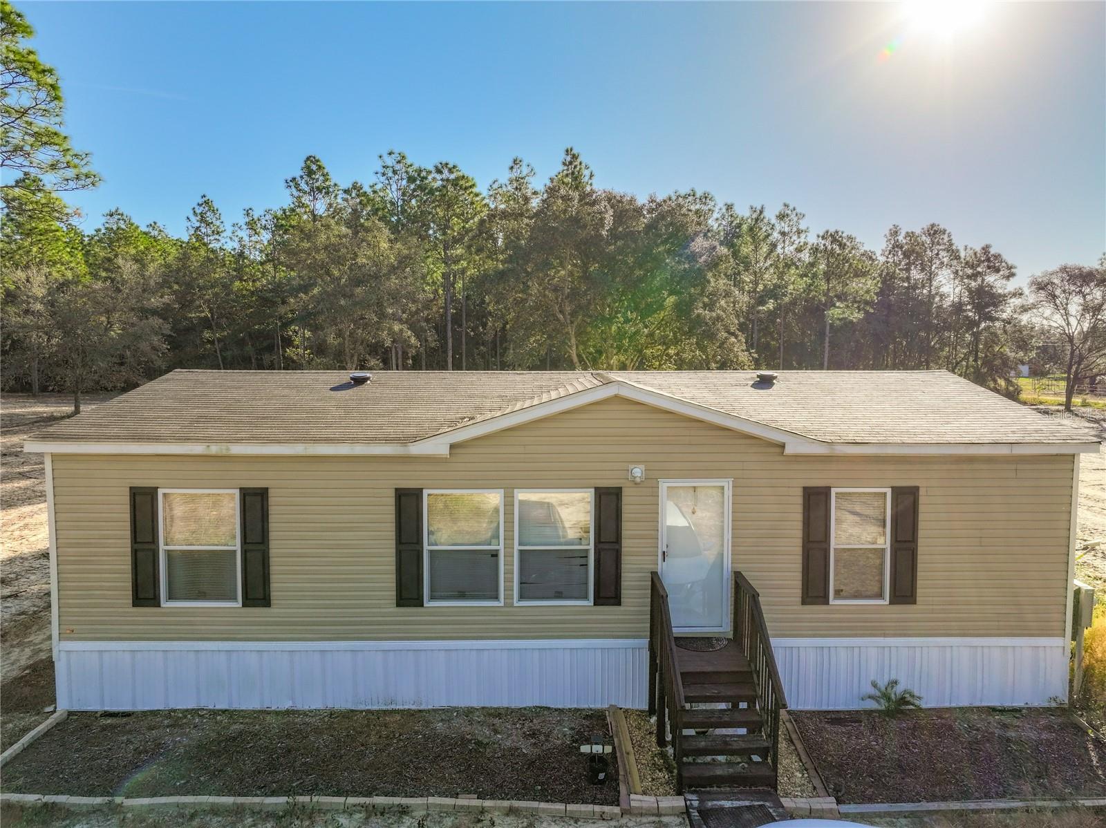 Discover peaceful country living just minutes from the conveniences of the city at this beautiful like new manufactured home on 2.50 acres in Archer Florida. Built in 2023, this modern move-in ready residence features approximately 1,144 sq ft of comfortable, open-plan living space, three bedrooms, two full baths — perfectly tailored for anyone seeking room to roam.
Outside you’ll find plenty of room for gardening, recreation or even a future workshop or barn — ideal for hobbyists, animals or simply enjoying the space.
Located in the quiet, friendly community of University Estates. You’ll enjoy quick access to nearby schools and major roadways while still getting the privacy and serenity of a countryside setting. 

Built in 2023 – modern construction and systems. 
1,144 sq ft of living space. 
Two full baths – great for guests or shared living. 
Generous 2.50-acre lot gives room to breathe and grow. 
Manufactured home style, thoughtfully sited and maintained. 

This one-of-a-kind home offers a rare combination of new-home comforts, rural acreage and proximity to everyday amenities — all without the urban hustle. Don’t miss the opportunity to make this Archer retreat your own.