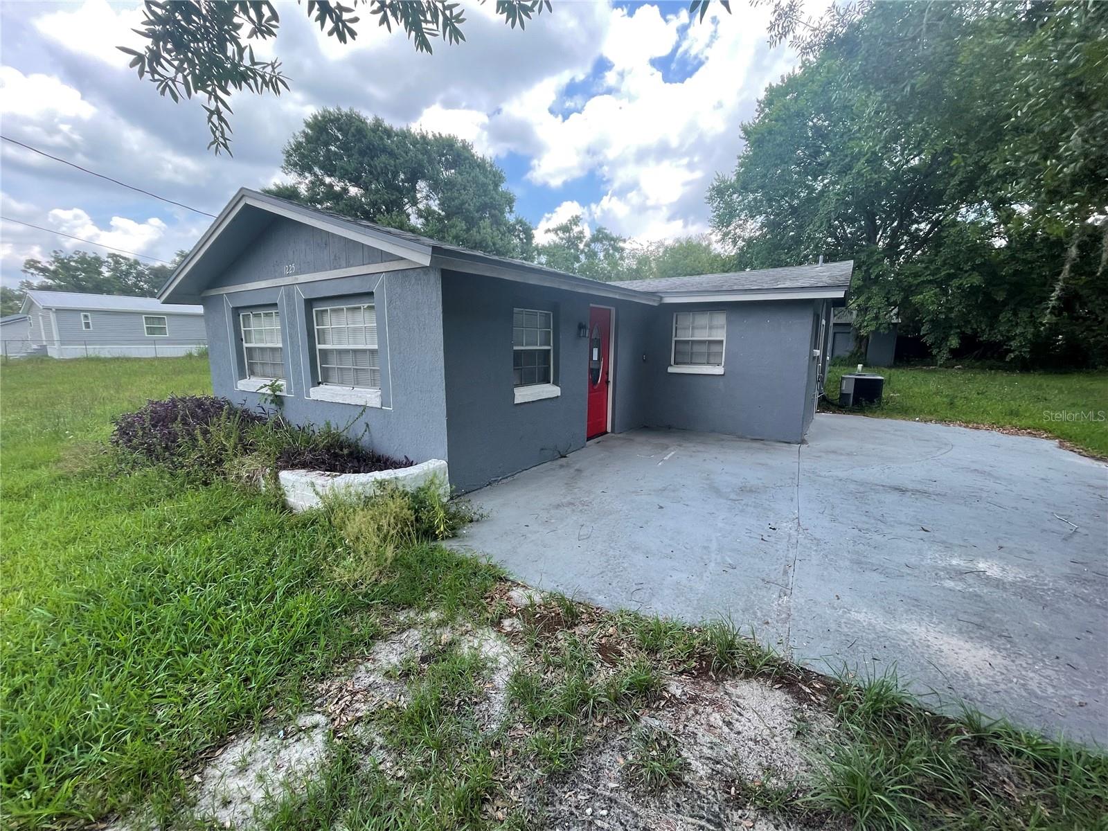 1/3-acre in Auburndale - with NO HOA or CDD! This home offers freedom with a central location. 4 bedrooms, 2 bathrooms, 1496 square feet with storage shed.  Step inside to a generously sized living area with updated wood vinyl flooring and an open concept floorplan. The kitchen and dining room are within easy conversational distance to the family room. The kitchen includes updated modern white cabinets and a tile backsplash, granite counters, white appliances and views of the private backyard. Utility room in conveniently located inside, directly off the kitchen. The primary suite includes closet, updated vanity and step in shower. The secondary bedrooms share a full size bathroom. Great location, near restaurants, shopping and the interstate. It's good to be home.
