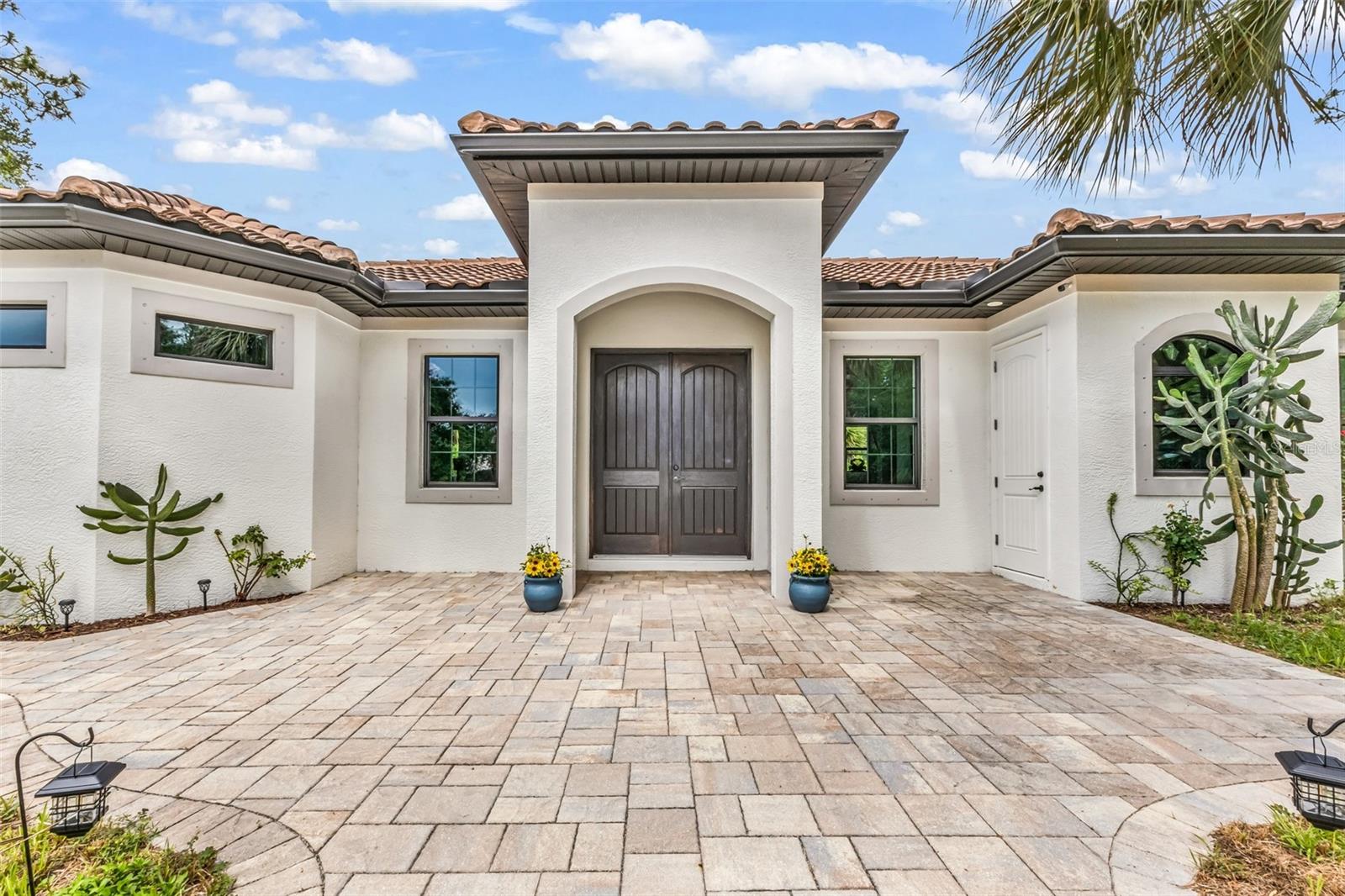 5 ACRE~~~ Immaculate equestrian setup with rare in-town convenience.  2020~ 3 bedroom, 2 bath, saltwater pool home Built by Quality homes. Featuring 1759 sq. feet under air, built on a stem wall, NON Flood Zone, barrel tile roof, hurricane shutters, tray ceilings with crown molding, Granite Island in kitchen & soft close doors. The master bedroom offers sliders to the pool, a walk-in closet, shower with overhead rainfall head with bench seat. Wood like tile throughout home. Cabana bath to pool. Inside laundry/mud room with private exterior door so no tracking clay/dirt from outside in. Approx. 46-foot saltwater lap pool with sun shelf and waterfall spillover with galvanized 4 foot fence surrounded by roses & Jasmine bushes. Front entry and pool deck with brick pavers. Horse barn was added in 2009 and is 48x32.  The comfortable barn has 5 fully matted stalls with fans and water. Three 12x12 stalls with attached runs and two 10x12 stalls that open directly to the pasture. The barn has its own well and electrical, and the tack room, tool room and kitchen/feed room are all air-conditioned. A large drum washer can easily handle pads, sheets, and blankets. The 165ft x 115ft professionally installed arena has a laser leveled base with a supportive and well-draining riding surface.  Barn also has hurricane protection. Extras: Aerated pond, Multiple fruit trees, Mature landscaping, solar powered gate, cross fenced, Pole barn for storage.