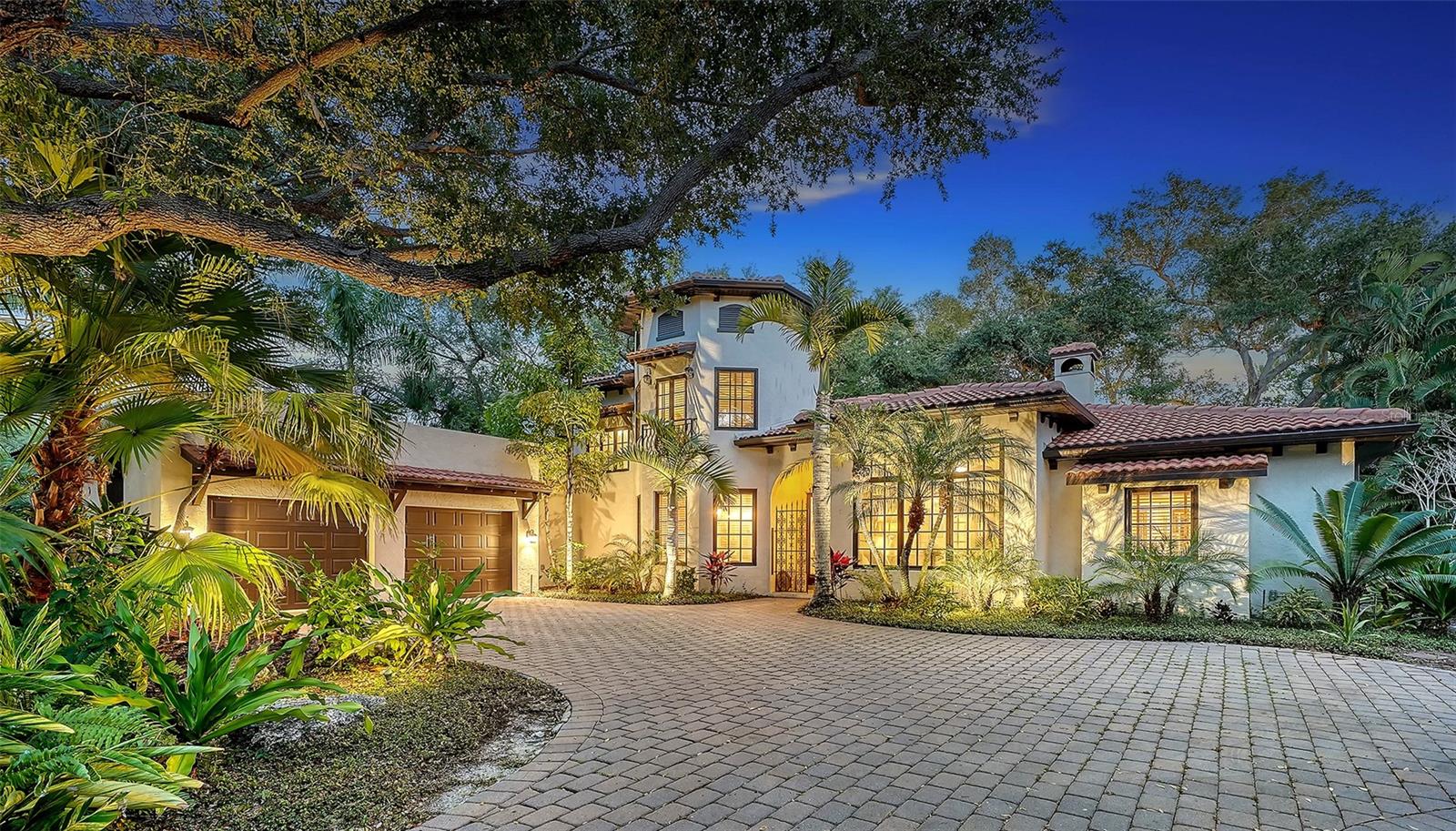 This beautiful residence sits on a rare half-acre lot within Old Oaks, an exclusive enclave of just six homes, privately tucked behind lush Florida landscaping. A set of double glass doors welcomes you into a light-filled interior where refined finishes and thoughtful upgrades create a warm atmosphere designed for both everyday living and effortless entertaining.
At the center of the home, the living room features a wood-burning fireplace and opens seamlessly through three sets of French doors to an expansive screened terrace. An additional fully enclosed outdoor living space with soaring ceilings overlooks a serene, botanical garden—offering a true indoor-outdoor lifestyle.
The kitchen is both stylish and functional, anchored by a large island with a farmhouse sink and complemented by a dedicated breakfast area. The primary suite serves as a private retreat, complete with French doors to the lanai, dual walk-in closets, and a spa-inspired en-suite bath featuring a wall-enclosed walk-in shower, soaking tub, and custom built-in cabinetry.
Upstairs, two generously sized bedrooms share a well-appointed full bath, providing comfort and privacy for family or guests. The oversized screened lanai offers ample space for entertaining, while the separate pool is surrounded by lush greenery, creating a tranquil setting for relaxation and recreation. An oversized two-car garage includes custom floor-to-ceiling storage.
Ideally located in the heart of Sarasota’s cultural district, this home is just minutes from downtown, St. Armands Circle, Lido Beach, and SRQ Airport. Enjoy close proximity to the Ringling Museum, Ringling College of Art and Design, and a short walk to Indian Beach Park for breathtaking bayfront sunsets. An exceptional opportunity to experience refined Florida living with modern comfort and timeless appeal.