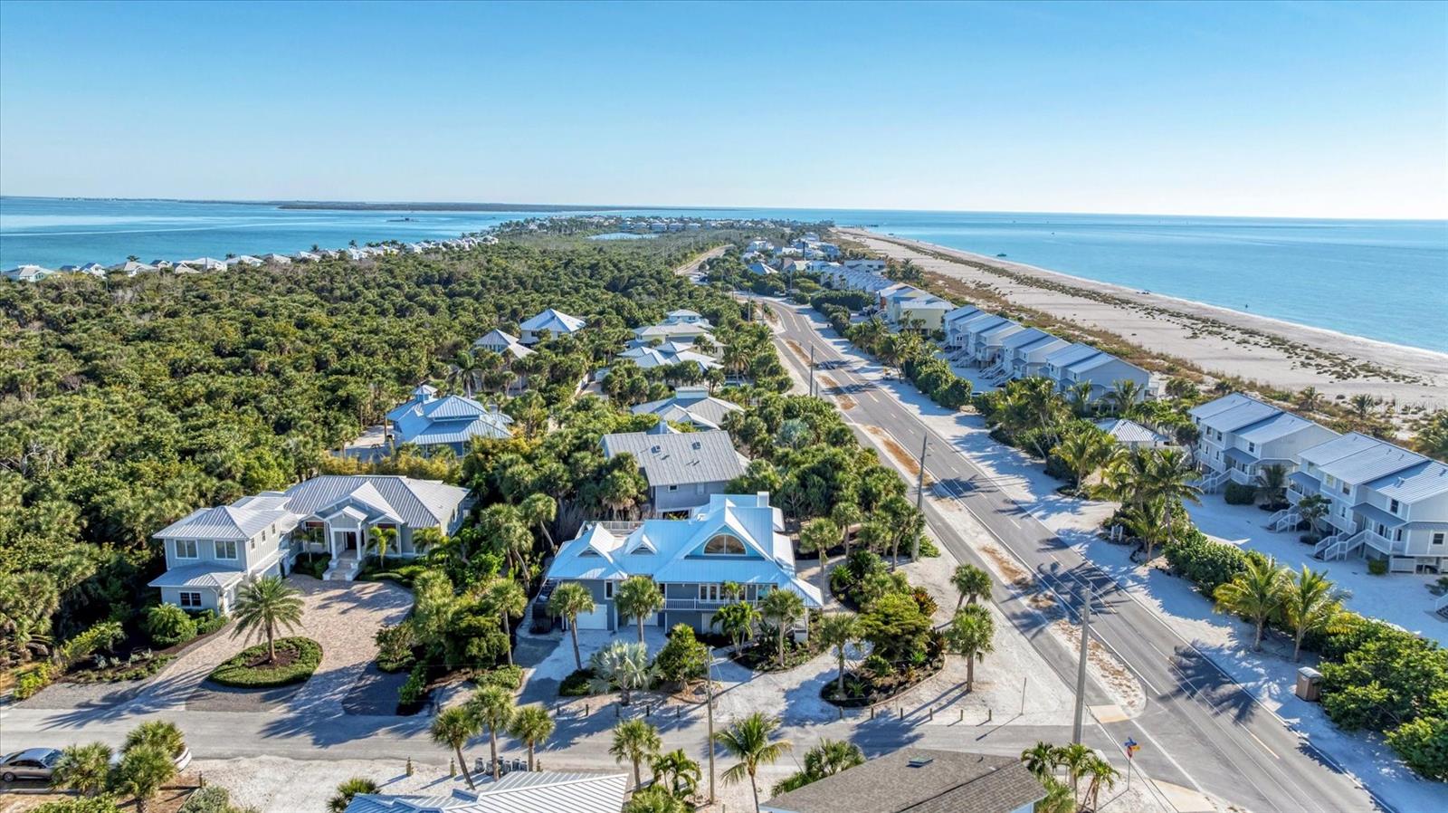 Perfectly positioned just steps from the sand, this Golden Beach coastal retreat offers a rare blend of comfort, privacy, and thoughtful design. This spacious 4 bedroom, 4.5 bath home is ideal for hosting family and friends or maximizing rental opportunities. Each bedroom offers its own private entrance, dedicated A/C, and full ensuite bath. Flooded with natural light, the interior features plantation shutters throughout, custom kitchen cabinetry, and a well-appointed kitchen equipped with premium appliances including a Sub-Zero refrigerator, KitchenAid cooktop, double oven, dishwasher, and a built-in wine fridge. Crafted with durability in mind, the home showcases solid cedar siding, a standing-seam metal roof, hurricane shutters, and a fire suppression system for added peace of mind. Outdoor living is truly exceptional. The spacious pool area features an elevated heated pool and spa, while durable Trex decking surrounds the home for low-maintenance enjoyment. Under the home, expansive storage areas provide space for beach gear, along with covered gathering areas ideal for entertaining. Parking is plentiful with a 2 car garage, 2 additional covered spaces, and generous driveway parking. Upstairs, a private loft balcony offers charming peekaboo Gulf views, the perfect place to unwind and enjoy Boca Grande’s iconic sunsets. All of this is just moments from the historic village, with easy access to dining, shopping, and the best of island living.