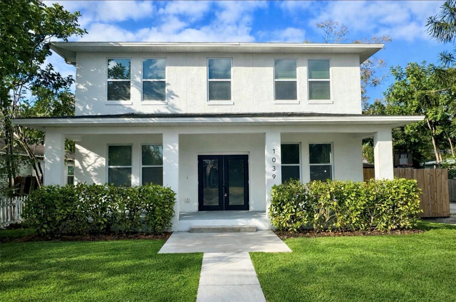 Welcome to 1038 53rd Ave N — a newly built 2024 luxury compound in the heart of St. Petersburg, offering the rare combination of a fully finished main residence and a private, income-ready guest home. This is multigenerational living and smart investment strategy, elevated.
The 4-bedroom, 3-bath main house is built for both everyday living and effortless entertaining. Step inside to a sun-filled great room that flows into a chef's kitchen: stone countertops, custom shaker cabinetry, stainless steel appliances, and a walk-in pantry. Covered lanais front and back stretch the living space outdoors year-round. A main-floor bedroom doubles as a guest suite or private office, while upstairs delivers a true owner's retreat — an expansive primary suite with a spa-inspired bath and a walk-in closet built, plus a dedicated bonus room and second-floor laundry for everyday convenience. Set privately behind the main home, the detached 3-bedroom, 2-bath ADU is finished to the same high standard — its own HVAC, separate utility meters, private entrance, balcony, garage, and parking. Move in extended family, host guests in style, or lease it out as a turnkey rental income stream. Just minutes from downtown St. Petersburg's top dining, culture, and beaches, this is a rare chance to own new construction with the flexibility.