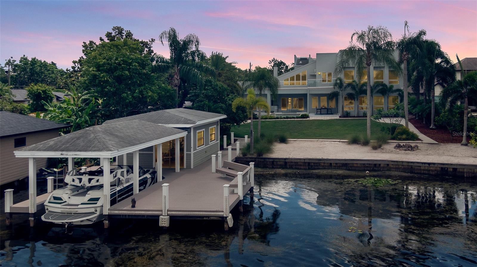 Located directly on the WINTER PARK CHAIN OF LAKES, this house was built in 2007 and COMPLETELY REMODELED in 2014, presenting this stunning contemporary home located ON LAKE MINNEHAHA. Featuring 4 bedrooms, 3.5 bathrooms, a flex room, laundry room, heated pool/spa, summer kitchen, covered boat dock with lift, a grandfathered-in boat house and a 2-car garage for a total of 4,868 sqft! The kitchen is appointed for a chef with THERMADORE INDUCTION RANGE, DOUBLE OVENS, SUB ZERO refrigerator and freezer, WINE CHILLER, THERMADORE dishwasher, an in-drawer microwave and built-in custom cabinets. The kitchen also features a beautiful full-size ISLAND with QUARTZ countertops with space for stools and a breakfast nook perfect for a round table and 8 chairs overlooking the pool. Just off the kitchen resides the laundry room, UPGRADED IN 2019 with built-in cabinetry by Walka Wood Co, an LG washer/dryer and an additional Whirlpool fridge/freezer. The dining room opens to the kitchen with room to hold a dining room table that seats 12 with a custom built-in buffet, cabinetry for storage and custom lighting. The living room located off the dining room, features a FLOOR-TO-CEILING WOOD BURNING FIREPLACE with mirrored DOUBLE MARBLE SLABS and has sliding glass doors opening to the SUMMER KITCHEN and outdoor area. On the opposite side of the kitchen and perfect for entertainment, is a PROFESSIONAL MOVIE THEATER/FAMILY ROOM with floor to ceiling windows and 22 ft high ceilings! The Owner’s Suite is DOWNSTAIRS with beautiful lake views, custom cabinetry, 2 closets and a large master bath.  Upstairs there are 3 bedrooms /2 bathrooms and a flex space with beautiful lake views perfect for an office, playroom, or gym. The upstairs gives access to a 1,600 square foot balcony with panoramic lake views that was just RENOVATED IN 2023. Don’t forget the backyard! This is where you will want to spend your time with your family and friends. As you travel to the lake, you pass the heated pool, spa and summer kitchen continuing to the lake you walk through the lush grounds to your sanded beach area and 133+ FEET OF LAKEFRONT on LAKE MINNEHAHA including a grandfathered in 600 SQUARE FOOT BOATHOUSE! There is a COVERED BOAT SLIP, with an automated lift, that will accommodate a Nautique g21 (21 foot+, 5800 lbs.+.)  The DOCK WAS RESURFACED IN 2015 with trex composite decking boards, installed with no surface nails. Freshly painted in 2023 - no detail was missed in this exquisite property! Centrally located to Winter Park, Park Ave, I-4 and great shops and restaurants. Call today to see 130 Minnehaha Circle in-person or virtually! <a href='https://www.zillow.com/view-3d-home/94654f0a-5608-47e8-9e61-e1fec6bd93fd?setAttribution=mls&wl=true&utm_source=dashboard'>https://www.zillow.com/view-3d-home/94654f0a-5608-47e8-9e61-e1fec6bd93fd?setAttribution=mls&wl=true&utm_source=dashboard</a>