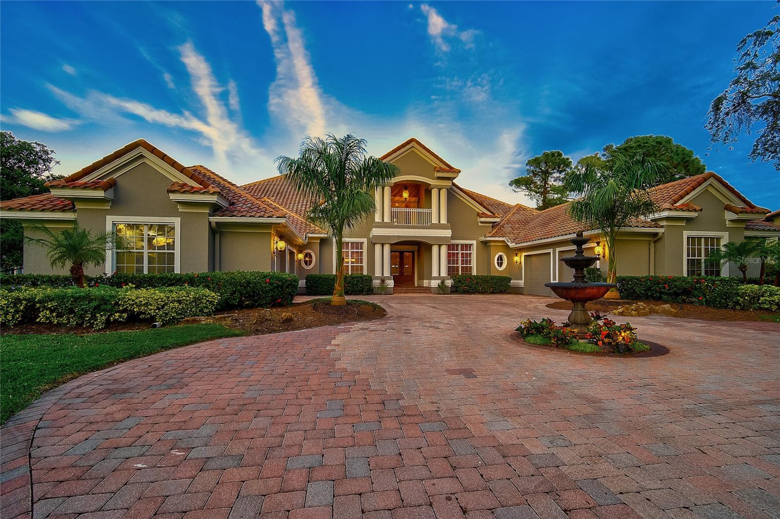 Virtually Staged. Set on a private cul-de-sac within The Oaks, this revitalized estate captures the essence of elegant Florida living. From the moment you enter, the home’s light-filled, open design and thoughtful updates make an immediate impression. The main living spaces flow effortlessly from the chef’s kitchen to expansive entertaining areas and out to the lanai, where golf course views frame the heated pool, spa, and outdoor kitchen.

The first-floor primary suite is a true retreat, featuring high ceilings, multiple closets, and a flexible sitting area that can serve as a nursery, gym, or private office. Upstairs, guests enjoy their own wing complete with a loft, theater, and screened terrace—ideal for relaxing or hosting in style.

A split four-car garage, custom finishes, and generous room throughout reflect the craftsmanship expected in one of Sarasota’s most distinguished country club communities. The Oaks offers 24-hour security, two championship golf courses, an acclaimed racquets program, fitness and wellness facilities, and fine dining—all just minutes from the beaches and top-rated schools.

Experience this home for yourself—take the 3D virtual tour and book your private showing today.
