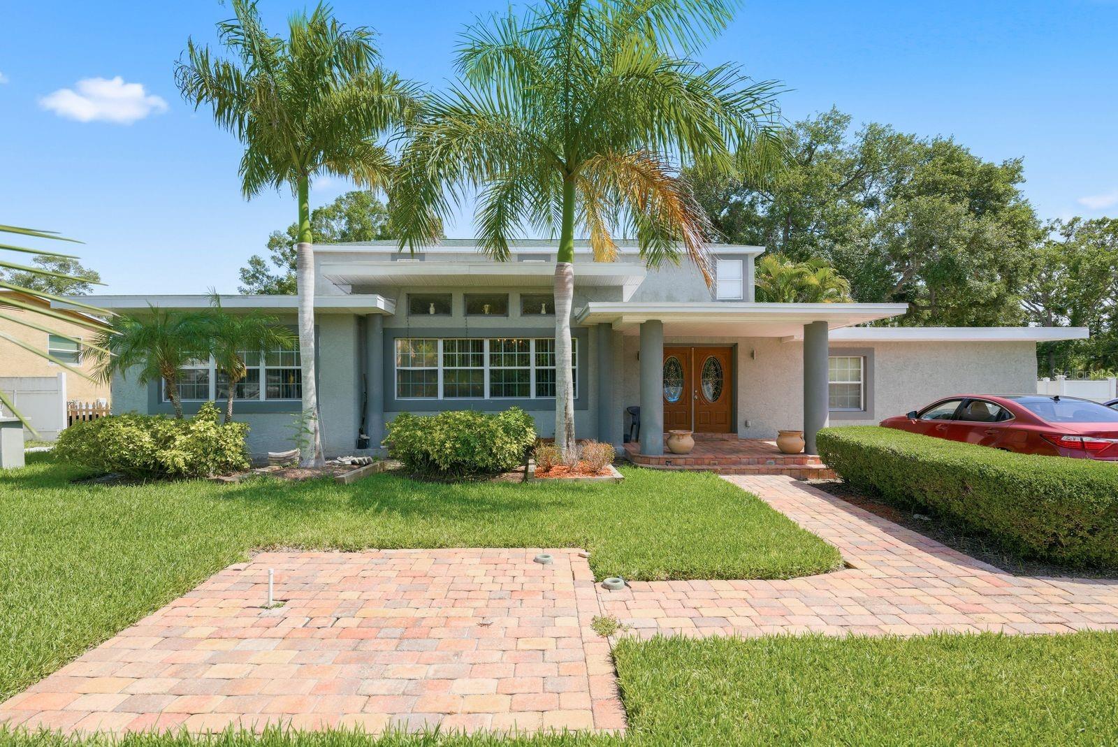 Seller is motivated—bring your offer!  Welcome to the exceptional South St. Petersburg lifestyle you've been dreaming of! This impressive 3,670-square-foot residence offers the perfect blend of spacious living, timeless comfort, and an unbeatable location just moments from beautiful Lake Maggiore.  From the moment you step inside, you'll be captivated by soaring ceilings, expansive living spaces, and an open, inviting floor plan designed for both everyday living and unforgettable entertaining. Adding a touch of timeless elegance, the living room showcases stunning imported marble flooring from Greece, creating a sophisticated focal point that elevates the home's luxurious feel.  Whether you're hosting holiday gatherings, celebrating with friends, or enjoying a quiet evening at home, this home offers room for everyone to spread out and relax. The private, fully enclosed backyard is your own peaceful retreat, offering the perfect setting for weekend barbecues, outdoor dining, playtime, or simply unwinding after a long day. Complete with a built-in entertainment area, it's ready to become the backdrop for countless memories.  Escape upstairs to your luxurious primary suite—an oversized sanctuary featuring dramatic vaulted ceilings, an expansive walk-in closet, and a spa-inspired en-suite bath with a soaking tub, separate shower, and plenty of space to recharge in comfort. Enhancing the elegance of this retreat, the primary bathroom features exquisite imported marble flooring and marble countertops from Greece, bringing exceptional craftsmanship and European sophistication to your daily routine.  With 4 generously sized bedrooms, 3 full bathrooms, and a thoughtfully designed layout, this home offers exceptional flexibility. The first-floor guest suite with its own large bathroom is ideal for multigenerational living, visiting family, long-term guests, or a private home office.  Lovingly maintained by owners who have taken tremendous pride in every detail, this move-in-ready home reflects true quality and care throughout. A rear-entry two-car garage provides convenience while enhancing the home's curb appeal.  Perfectly situated just minutes from Lake Maggiore and Grandview Park, you'll enjoy easy access to scenic walking trails, bike paths, parks, and outdoor recreation. Spend your weekends exploring vibrant downtown St. Petersburg's renowned waterfront, award-winning restaurants, boutique shopping, museums, and entertainment, then finish the day with breathtaking sunsets on Florida's world-famous Gulf beaches—all just a short drive away.  This is more than just a home—it's an opportunity to enjoy space, comfort, luxury, and one of South St. Petersburg's most convenient locations. Don't miss your chance to make this incredible property your own!