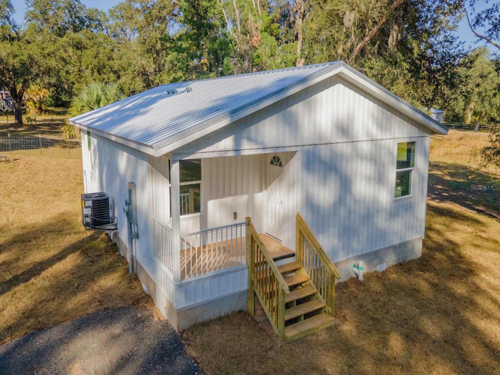 New Construction on Three Lots with Pole Barn Kit Included

11629 NE 145 Place, Fort McCoy, FL 32134
3 Bedrooms | 2 Bathrooms | 936 Sq Ft | Built 2025 | .75 Acres (3 Lots)

Rarely do you find a brand-new home with this much land in the Fort McCoy area! Situated on three lots totaling approximately .75 acres, this newly completed 2025 home offers modern construction, quality finishes, and room to grow.

Designed for easy living, this attractive home welcomes you with a covered front porch, durable metal roof, fresh landscaping, and a spacious yard with endless possibilities. Whether you're looking for space to build a workshop, park recreational vehicles, start a garden, or simply enjoy extra privacy, this oversized property provides the flexibility many buyers are searching for.

Inside, you'll find a bright and open floor plan highlighted by cathedral ceilings, recessed lighting, and luxury vinyl plank flooring throughout. The thoughtfully designed kitchen features granite countertops, solid wood soft-close cabinetry, a pantry, and a complete package of stainless-steel appliances. The open living and dining areas create a comfortable atmosphere for everyday living and entertaining.

The primary suite includes a spacious closet and a beautifully finished bathroom with a tiled shower, glass enclosure, granite vanity top, and modern fixtures. Two additional bedrooms provide room for family, guests, or a home office. The guest bathroom features a steel tub with tiled surround, granite countertop, and matching quality finishes.

Adding even more value is a 24' x 30' x 10' pole barn kit included with the property. Constructed with 6x6 wood posts, metal trusses, and a metal roof, this structure is ready for future use as equipment storage, RV parking, workshop space, or additional covered storage. The structure currently includes no slab, walls, or electrical service, allowing the new owner to customize it to their needs.

Located within minutes of downtown Fort McCoy, you'll enjoy convenient access to grocery shopping, dining, pharmacy services, hardware stores, and everyday necessities. Outdoor enthusiasts will appreciate the property's proximity to the Ocklawaha River, Ocala National Forest, Salt Springs, Silver Glen Springs, and Juniper Springs, offering endless opportunities for boating, fishing, hunting, hiking, and trail riding.

This is a unique opportunity to own a brand-new home with acreage, room for expansion, and modern finishes in one of North Central Florida's most affordable markets.

Don't miss your chance to own this move-in-ready home with space to live, work, and play. Schedule your private showing today!